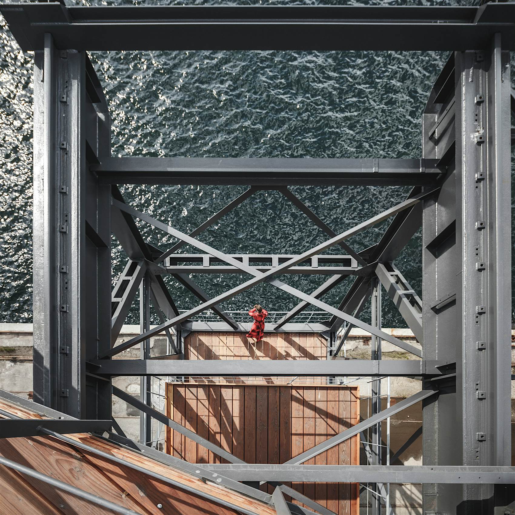 Travel News - The Krane Copenhagen rental travel luxury A woman looks out of Nordhavn Habour on The Krane in Copenhagen