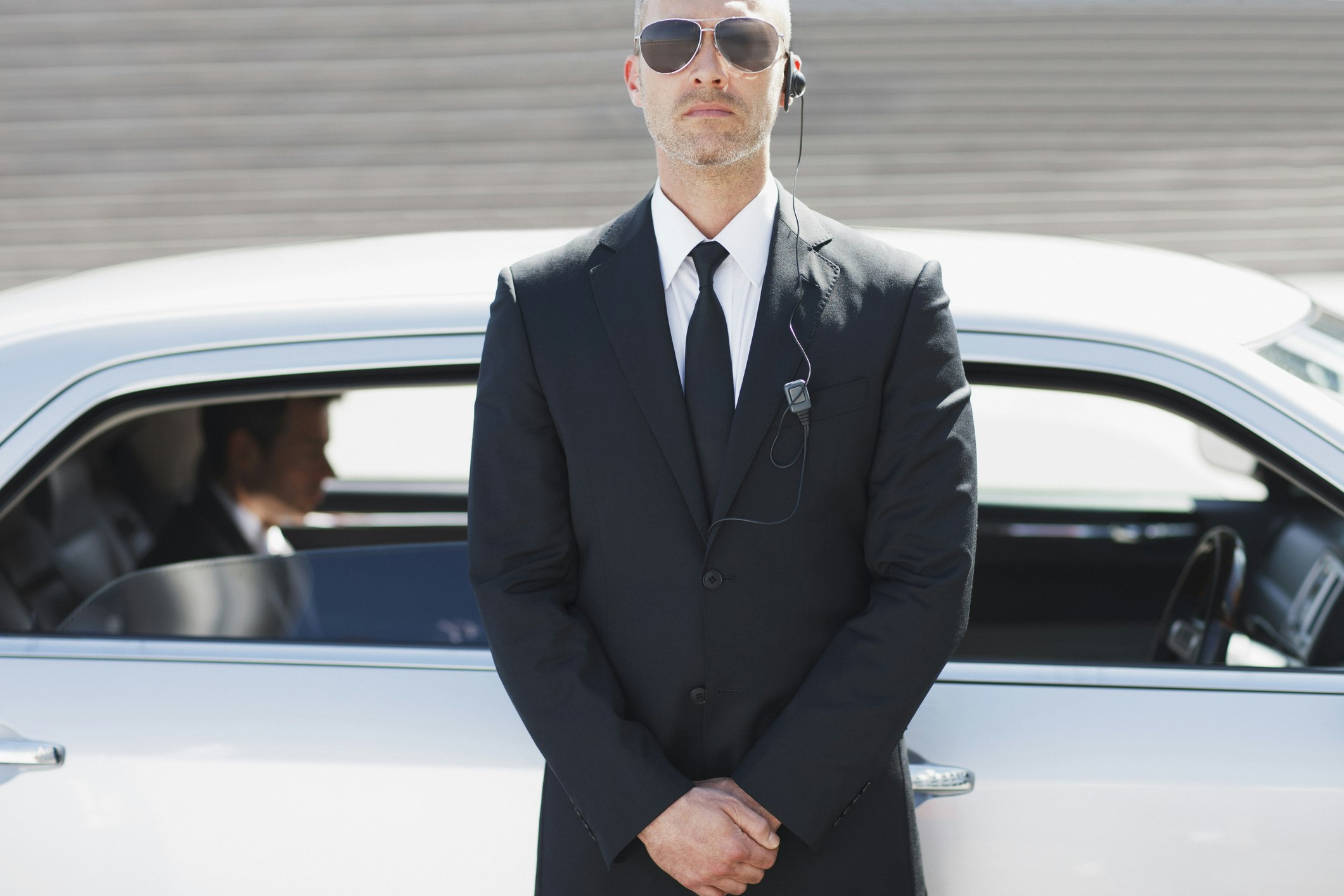 Travel News - Security guard standing by car