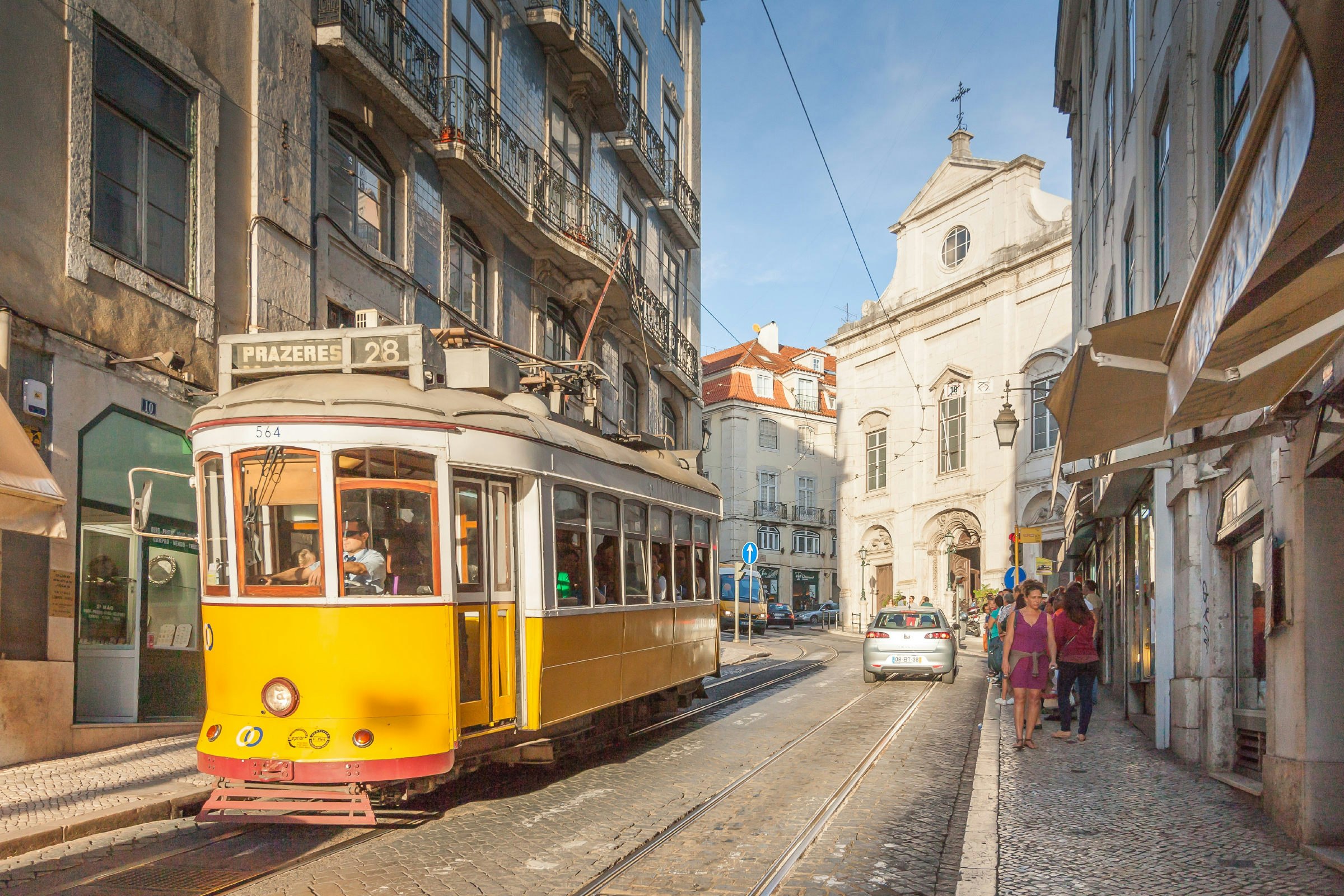 One of Lisbon's classic trams travels through the streets.