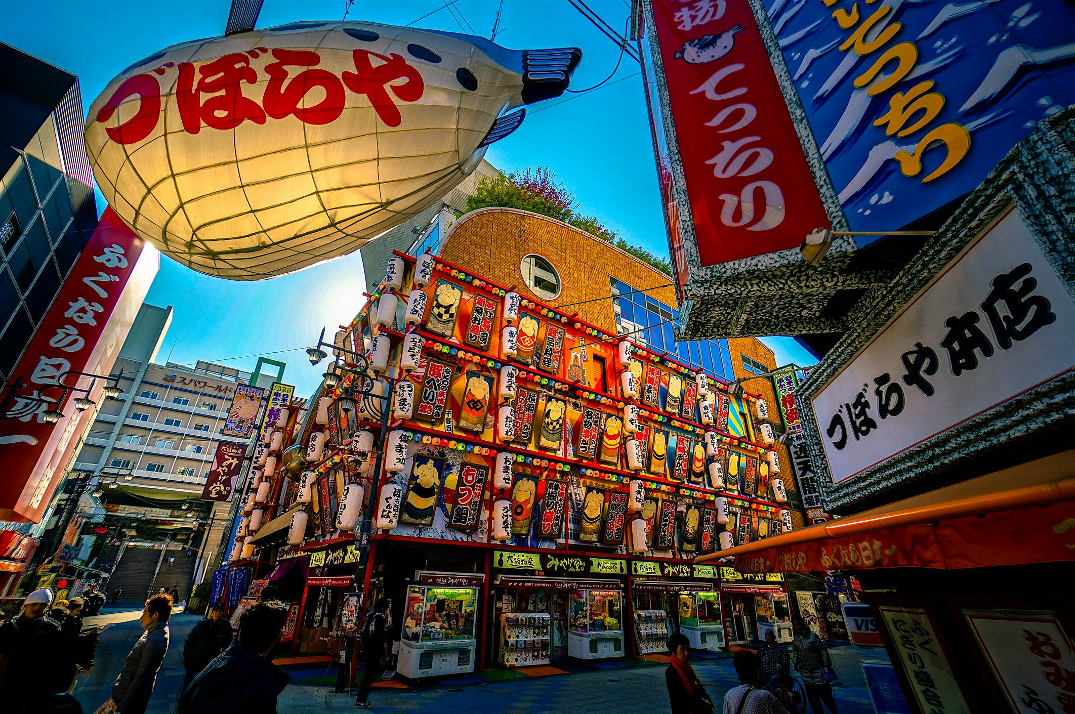 Travel News - oaska There are many interesting restaurants in Shinsekai area with famous fugu (blowfish) and kushi-katsu cuisine, in Osaka Japan.