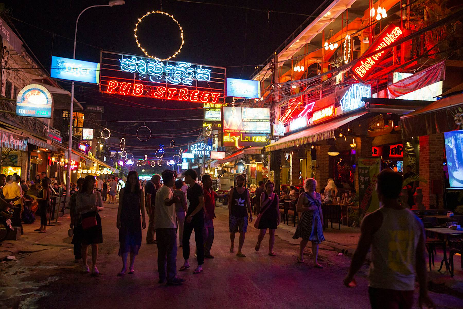 Travel News - pub street clean up siem reap Tourists walk past shops, restaurant and bars at night on Pub Street in downtown Siem Reap, Cambodia, Asia. Siem Reap is the capital city of the Siem Reap Province. Pub Street is a famous destination for lively nightlife for tourist and travellers as it restaurants and bars stay open late