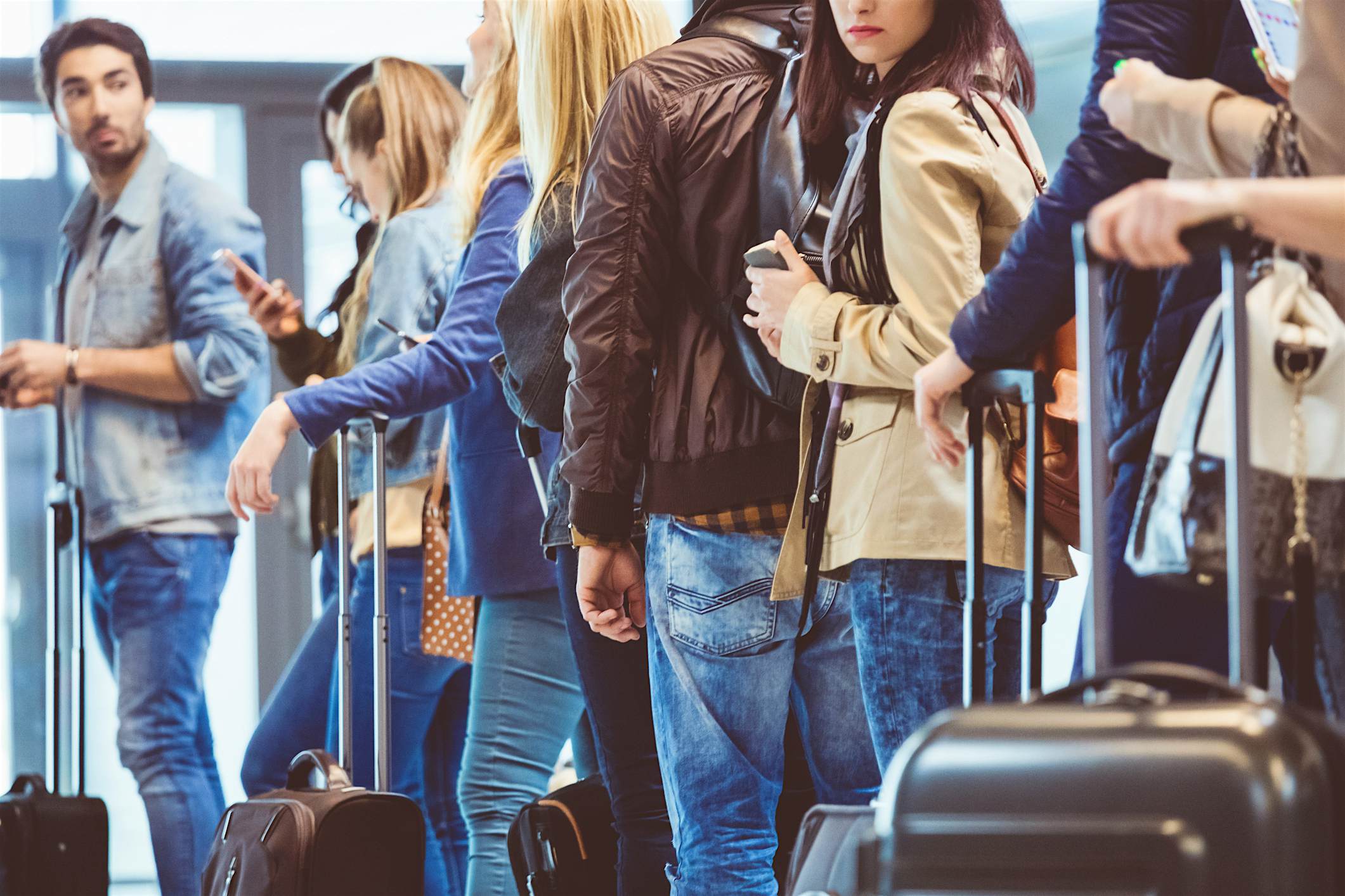 Travel News - Queue of travelers waiting at boarding gate at airport The US is set to experience the highest volume of Thanksgiving travellers since 2005.