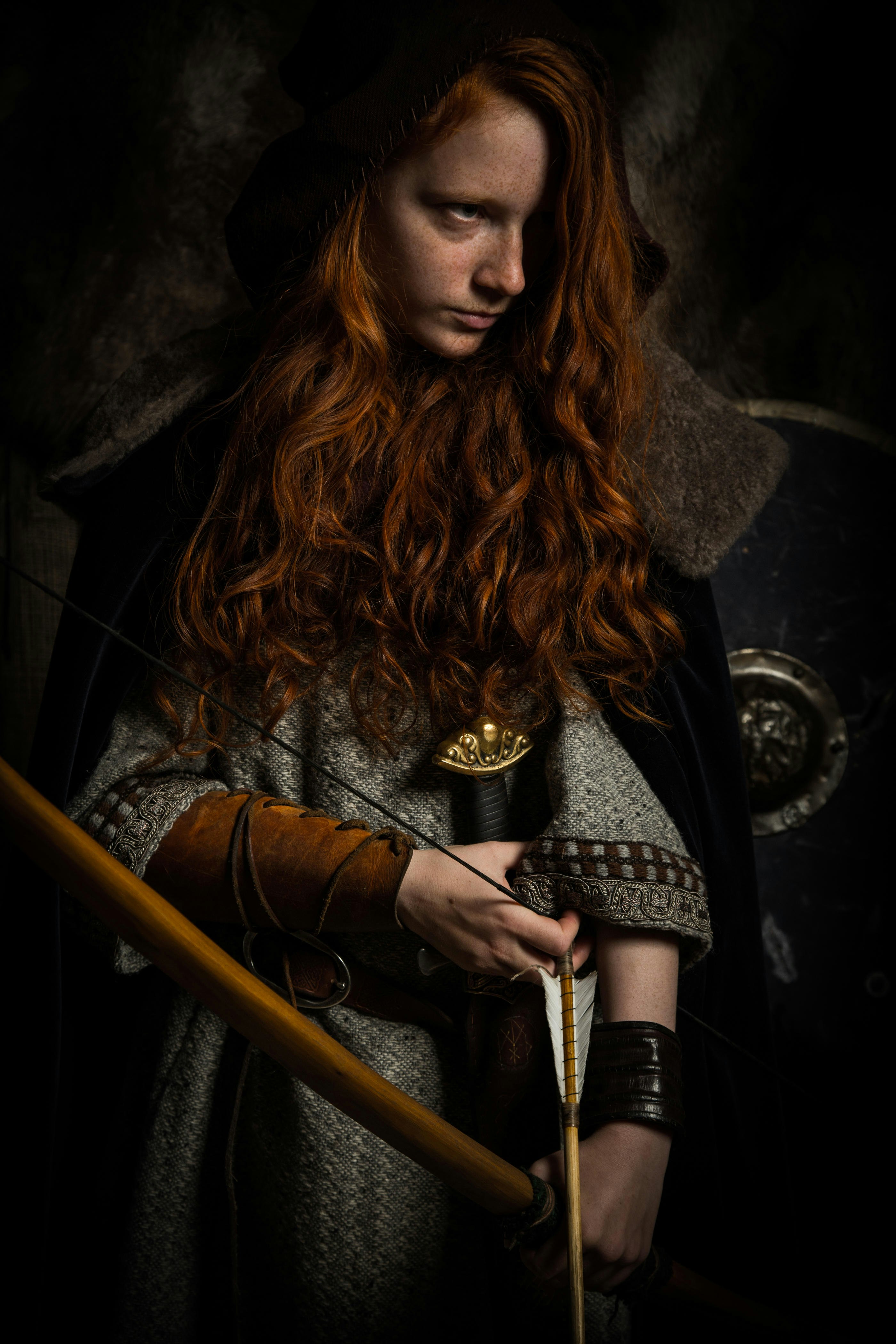 Woman posing with Viking weapons