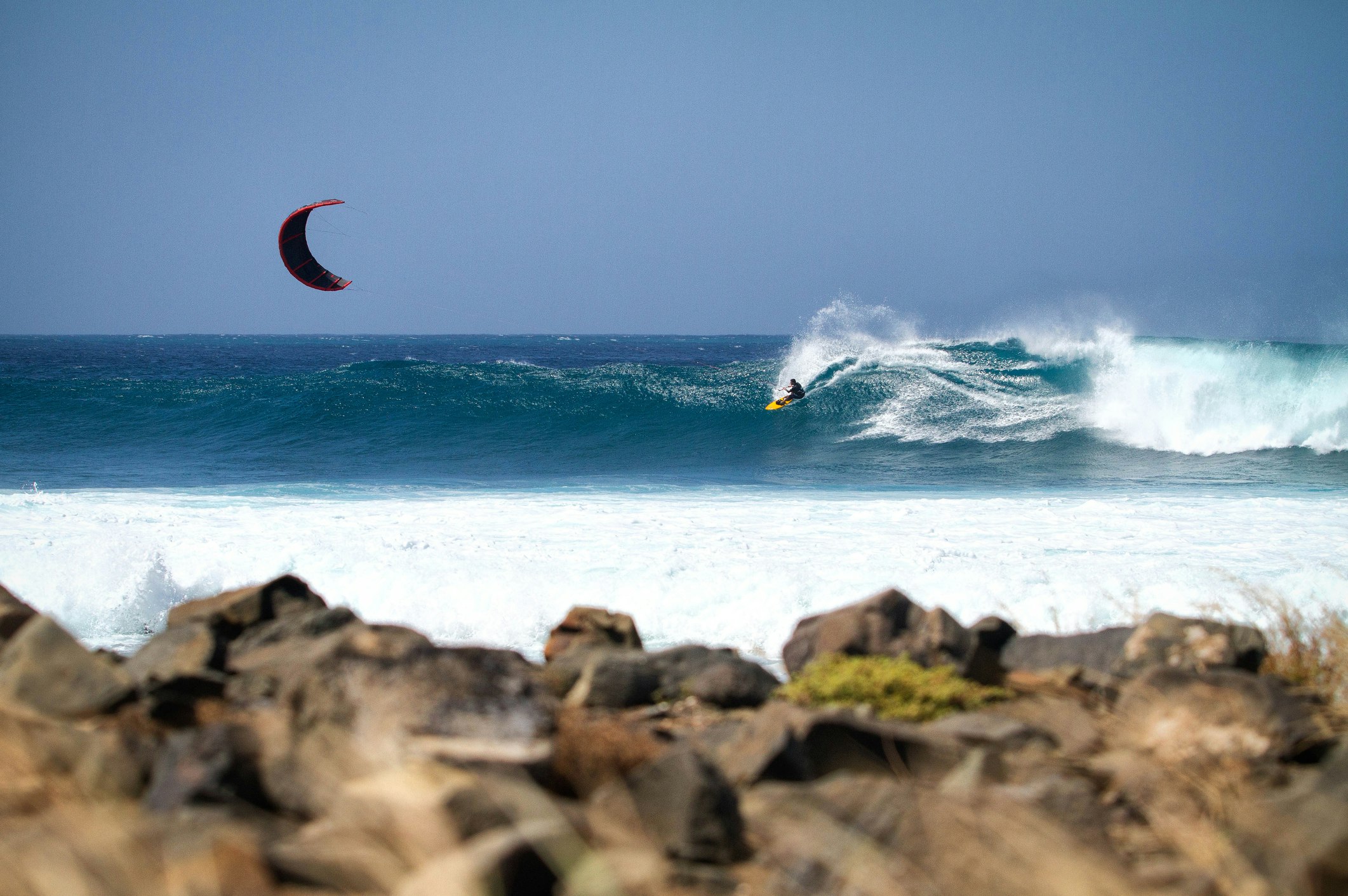 Travel News - A kitesurfer on a wave in Cape Verde.