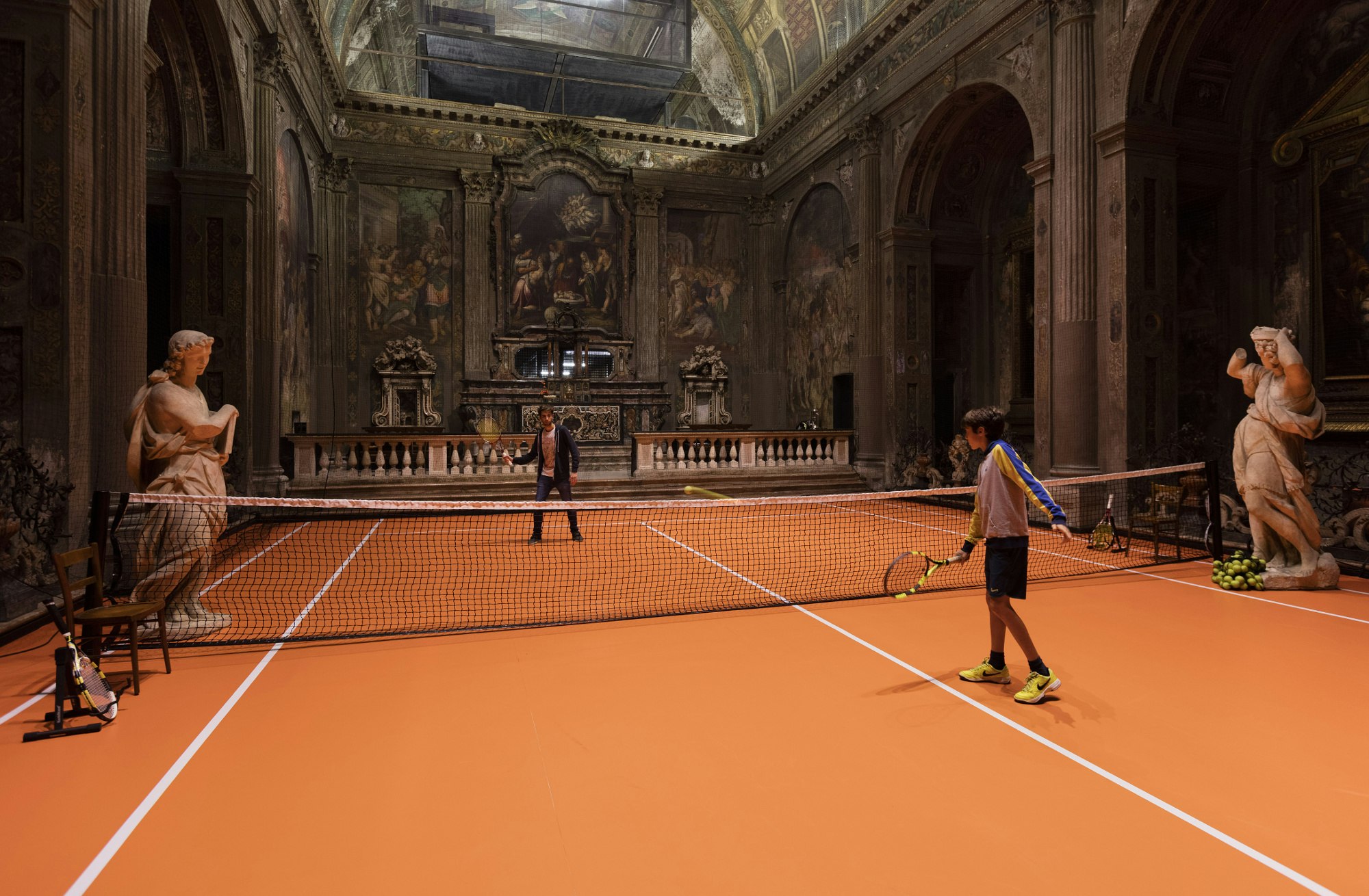 The installation allows visitors to practice their tennis skills inside a unique space.