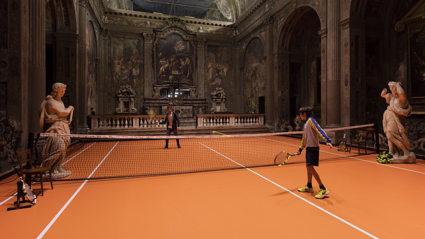 The installation allows visitors to practice their tennis skills inside a unique space.