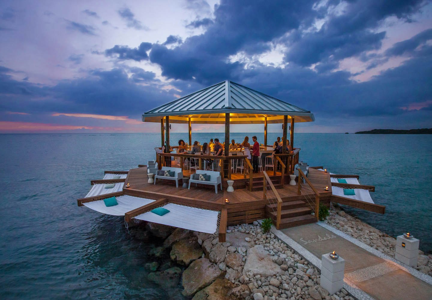 Latitudes Bar, featuring cantilevered hammocks and ocean views.