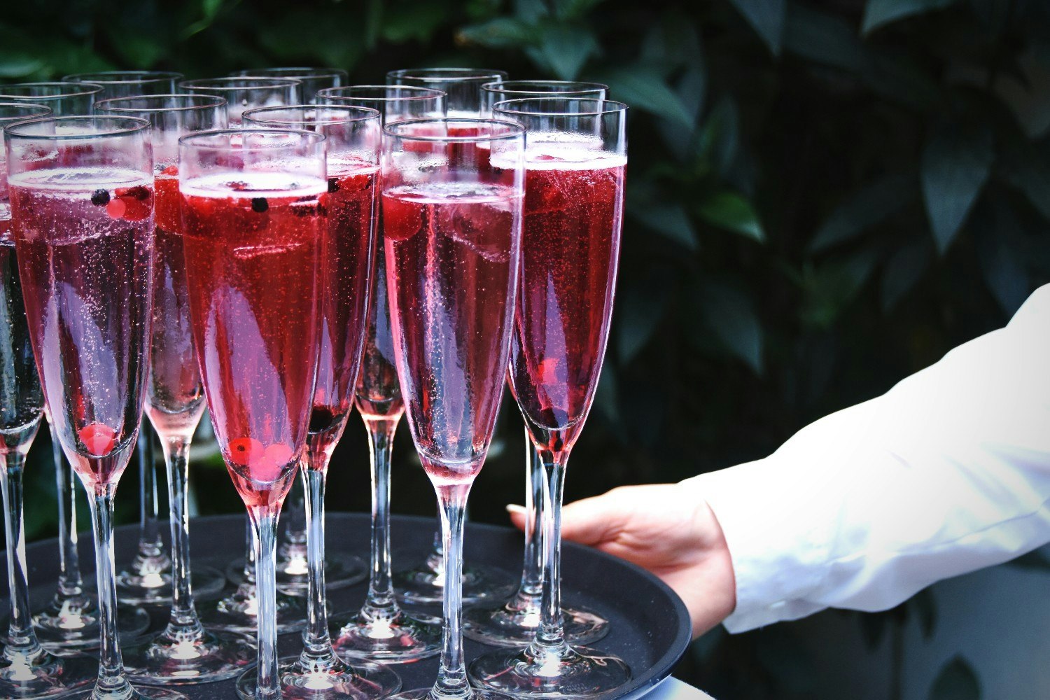 Rosé wine in glasses on a tray.