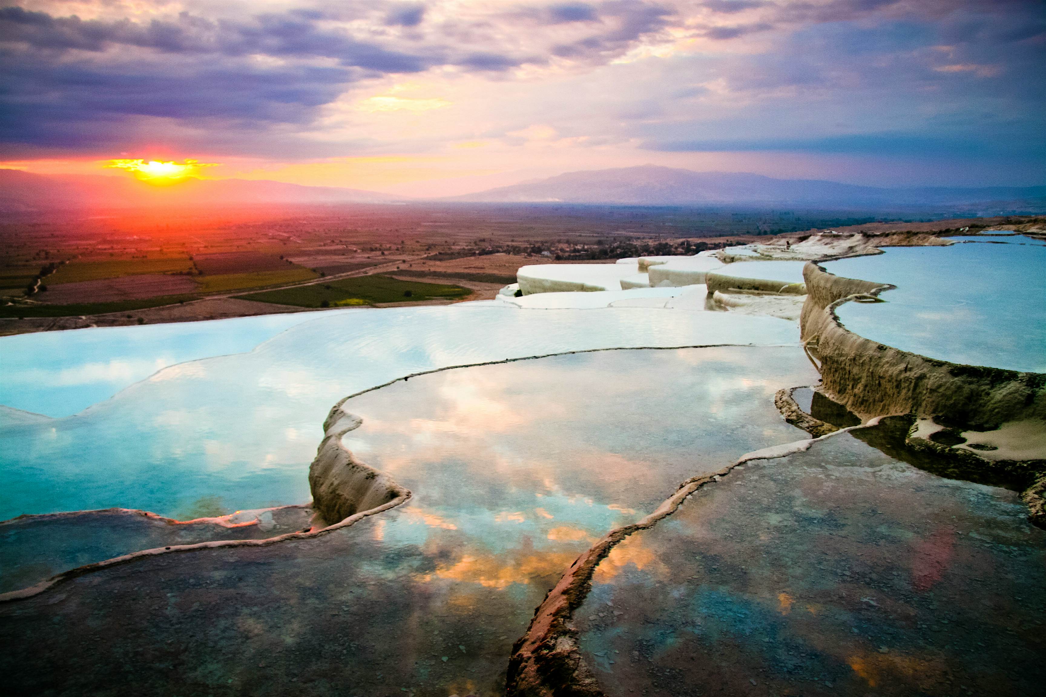 Travel News - Pamukkale Pools Layers of travertines form terraces of carbonate minerals in Pamukkale, Southwest Turkey.
