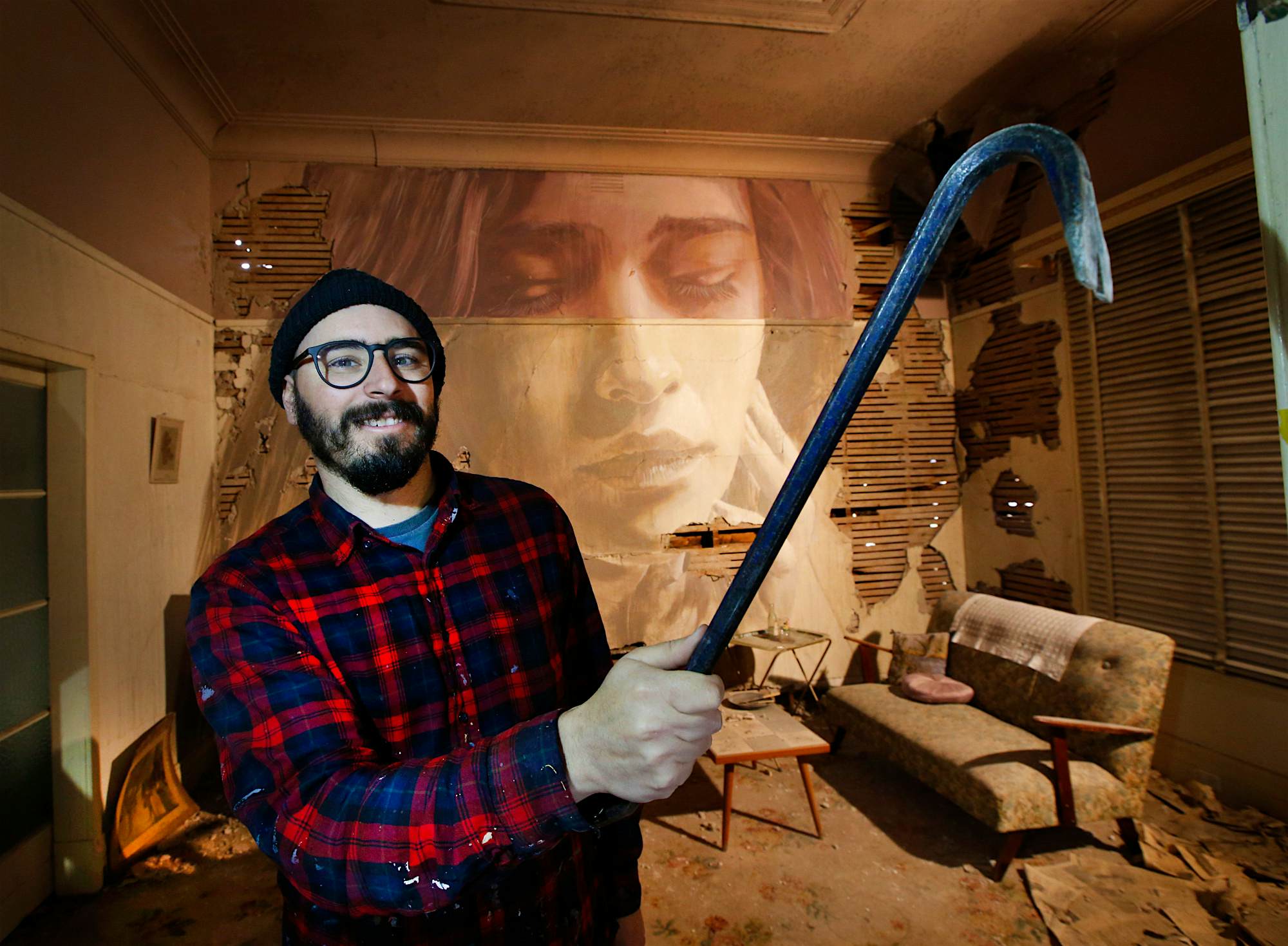 Travel News - The artist Rone at work on a temporary gallery in Melbourne. Photo by David Caird Newspix Getty Images The renowned artist Rone at work.