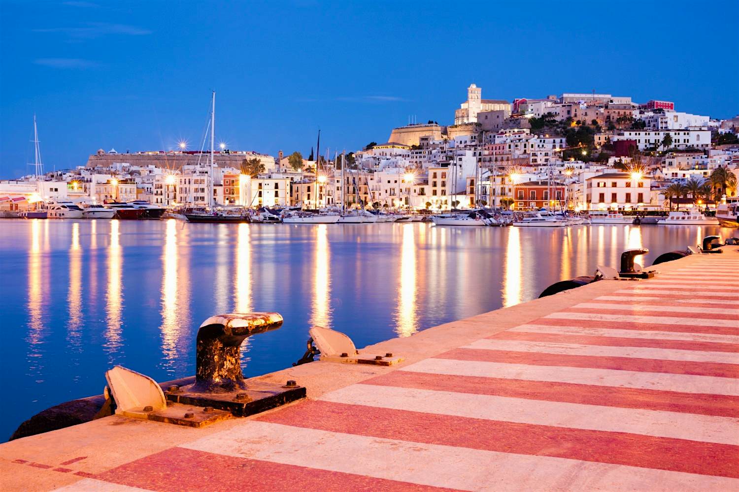 Travel News - GettyRF_177222045 A view of Ibiza from across a harbour.