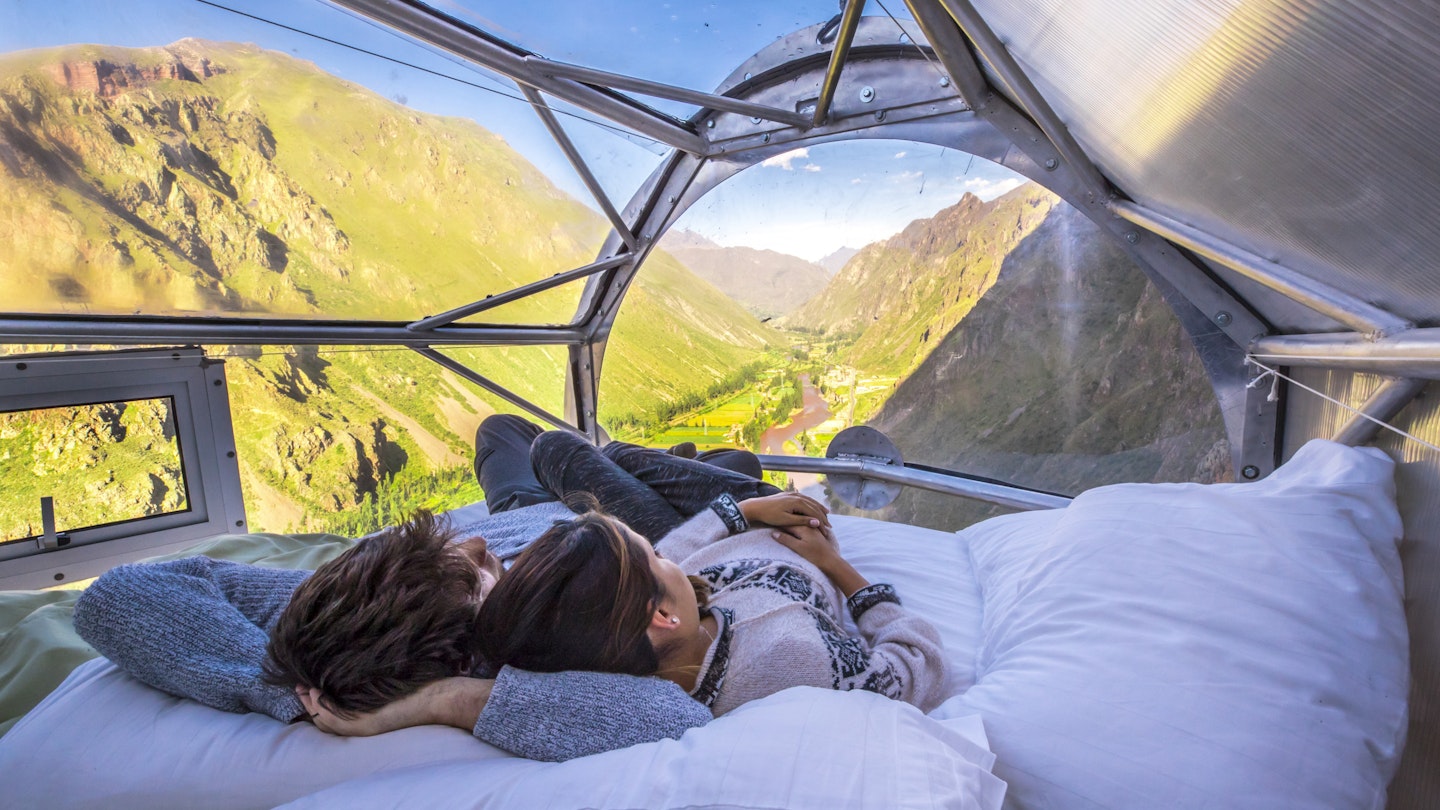 Guests can sleep beneath the stars, perched on the side of a cliff in the Sacred Valley of Peru.
