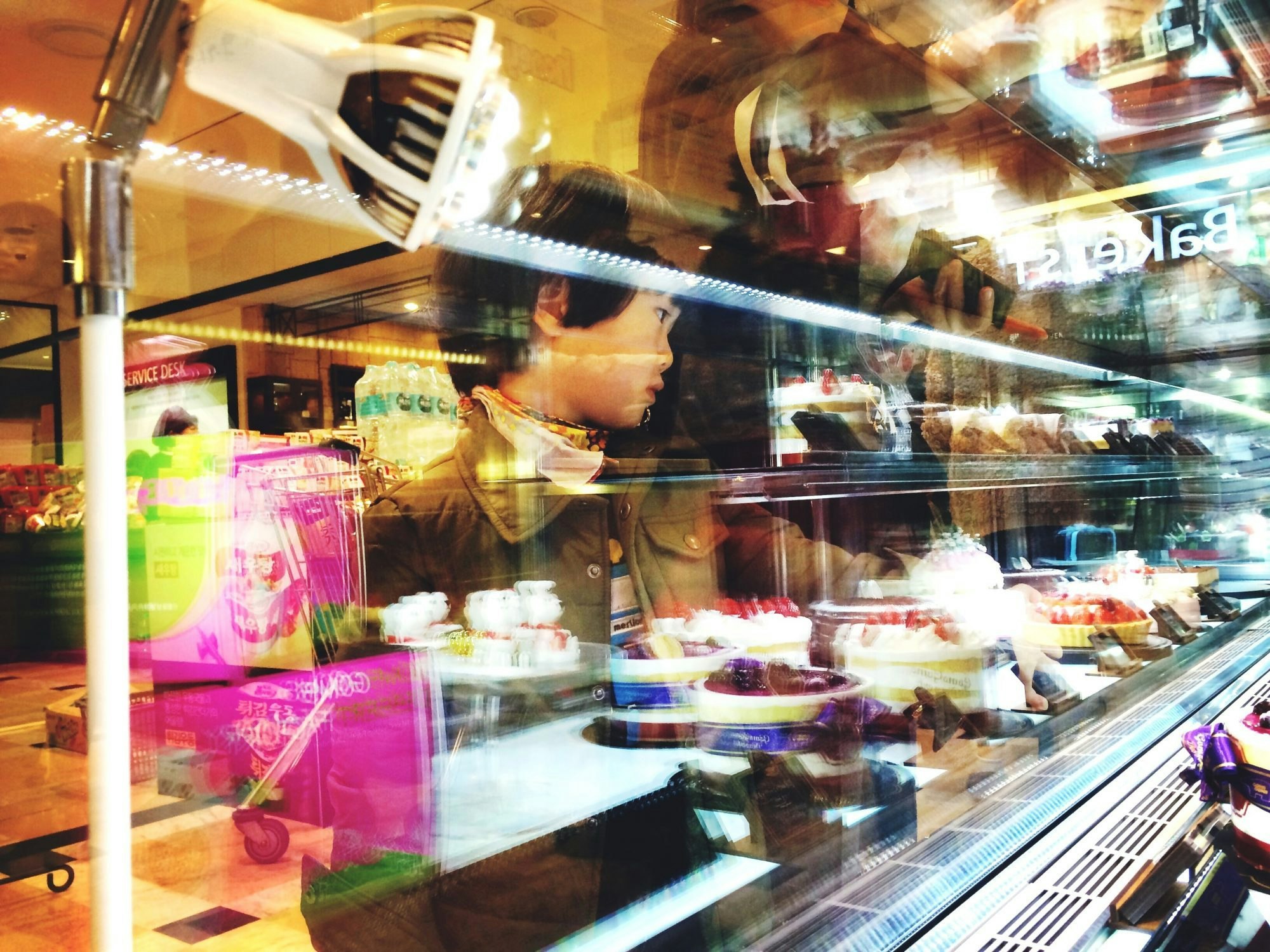 Travel News - Little Boy Looking At Cakes At Bakery Store