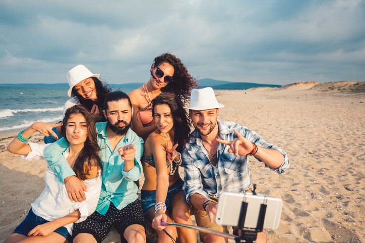 Friends at the beach taking selfie