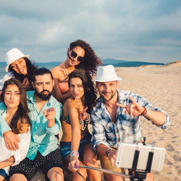 Friends at the beach taking selfie