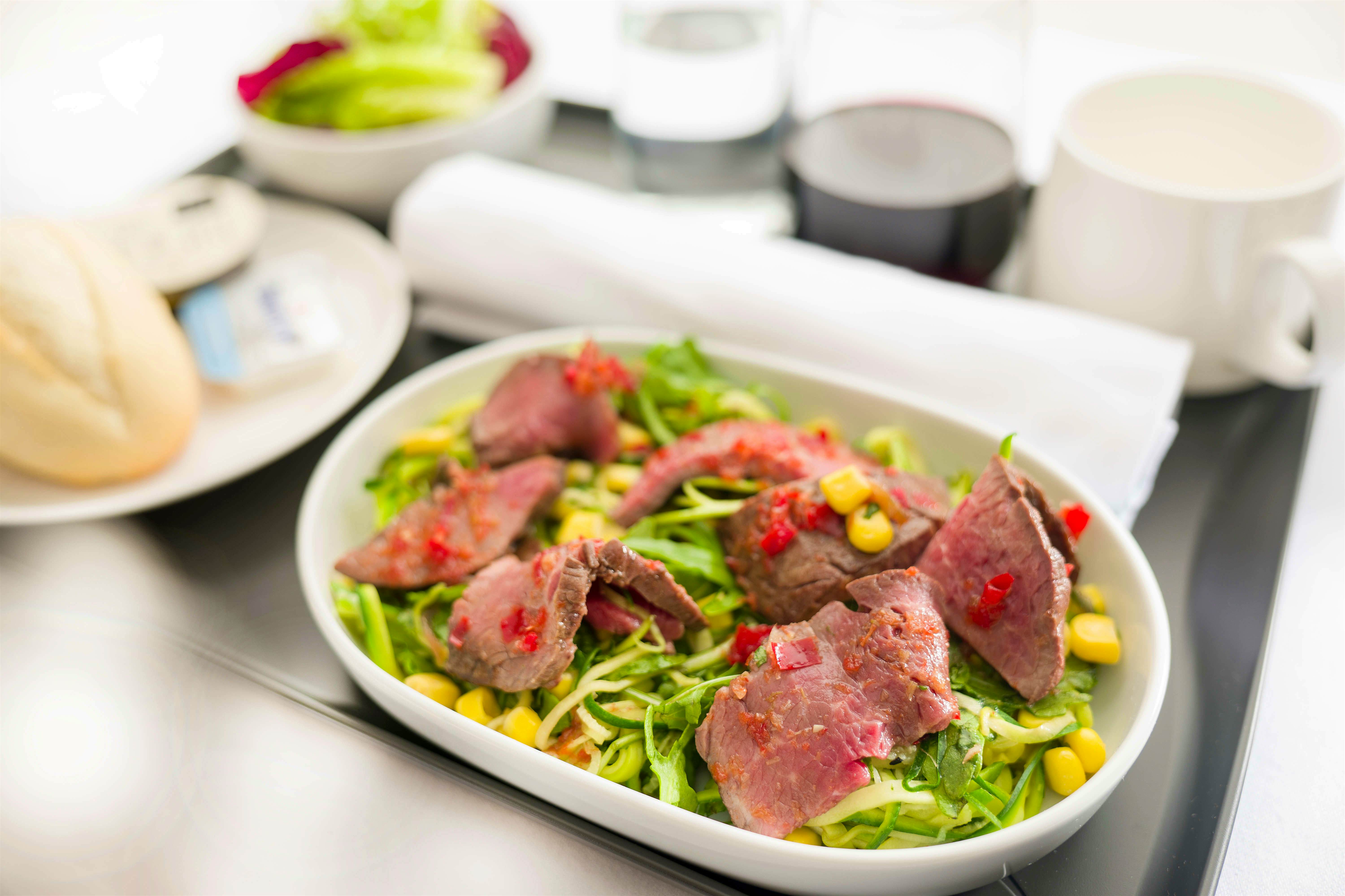 Travel News - Salad of cumin spiced beef with zucchini, corn and a citris dressing - Economy and Premium Economy menu ex PERLHR B787 QF9 Travel News - Salad of cumin spiced beef with zucchini, corn and a citris dressing - Economy and Premium Economy menu ex PERLHR B787 QF9
