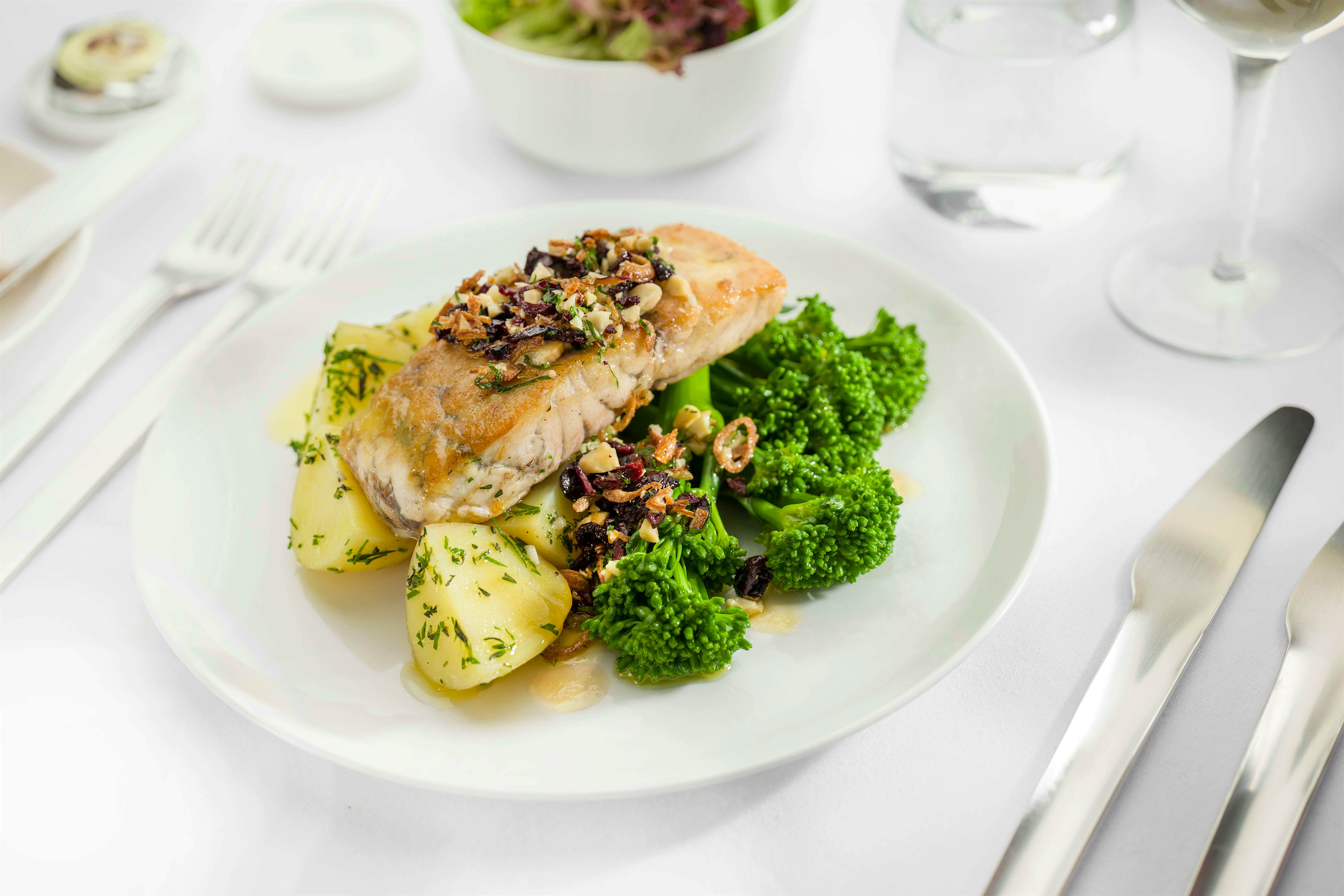 Travel News - Seared Cone Bay barramundi with herbed garlic potatoes, broccolini, lemo, olive and almond sala - Business menu ex AUS Travel News - Seared Cone Bay barramundi with herbed garlic potatoes, broccolini, lemo, olive and almond sala - Business menu ex AUS