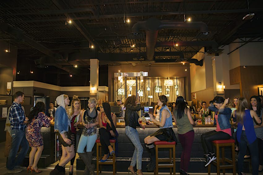 Travel News - Friends talking around bar Travel News - Friends talking around bar