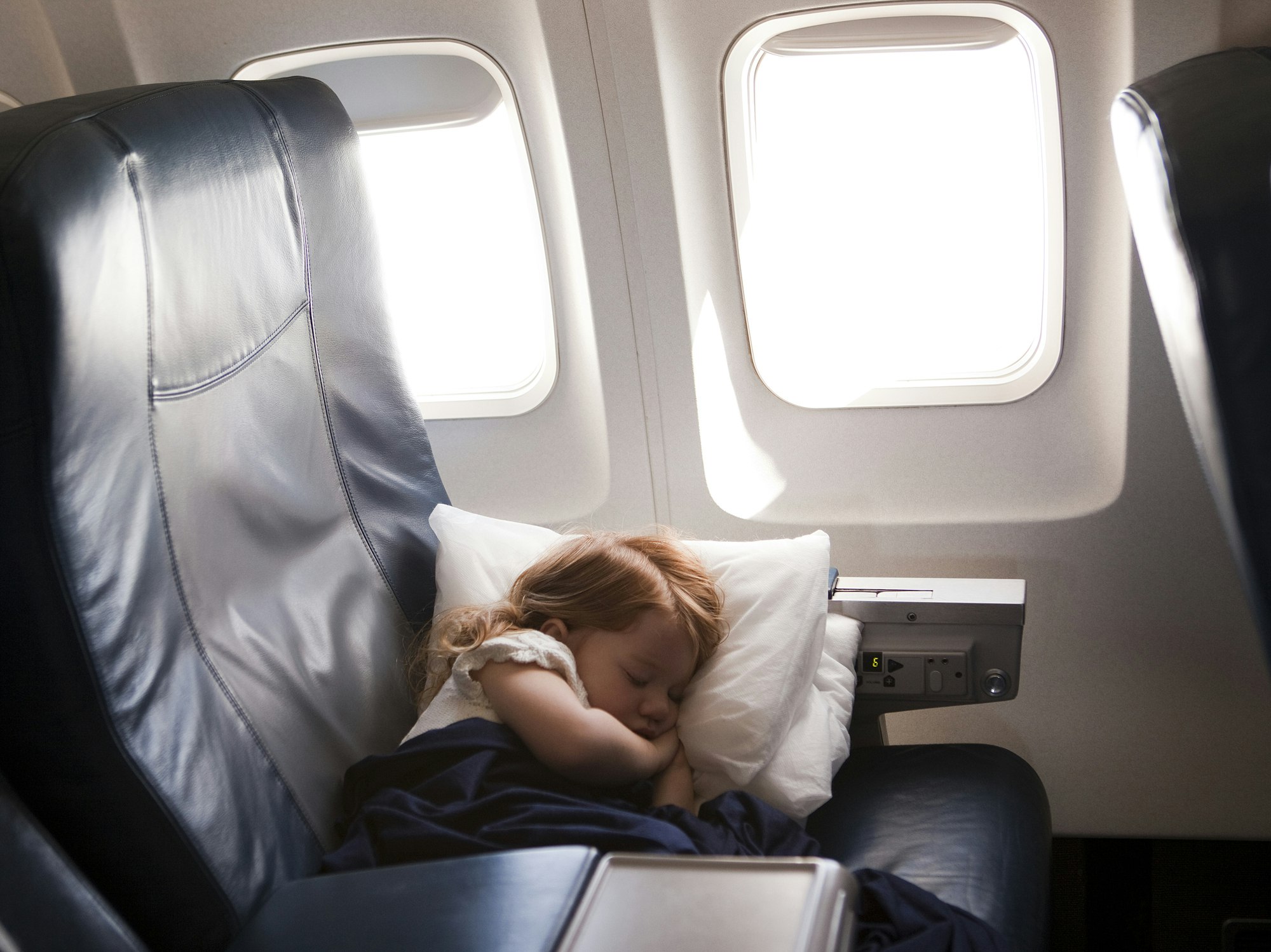 Travel News - girl (2-3) sleeping in airplane seat