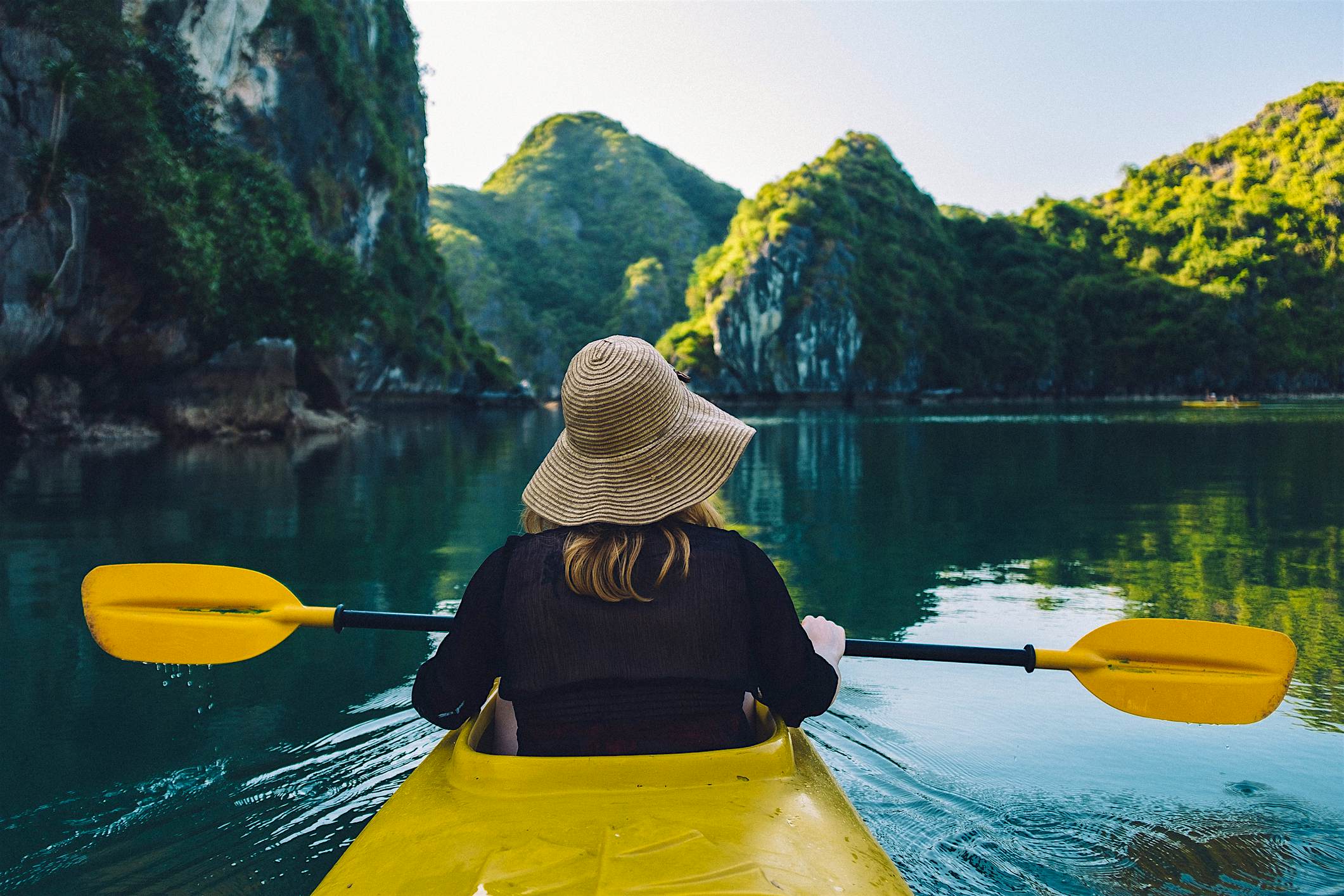 Travel News - Rear View Of Woman Kayaking On River Travel News - Rear View Of Woman Kayaking On River