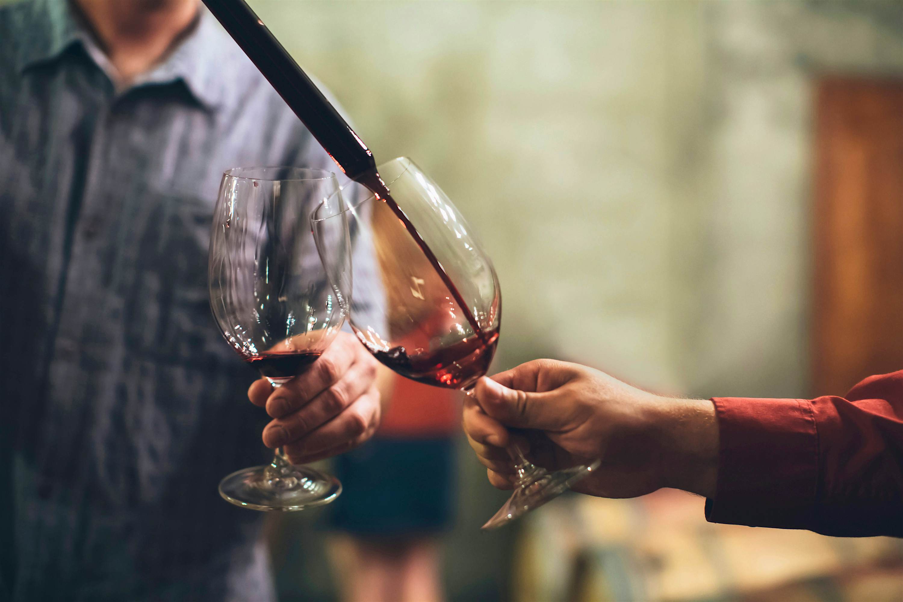 Travel News - Caucasian men tasting wine in cellar Travel News - Caucasian men tasting wine in cellar