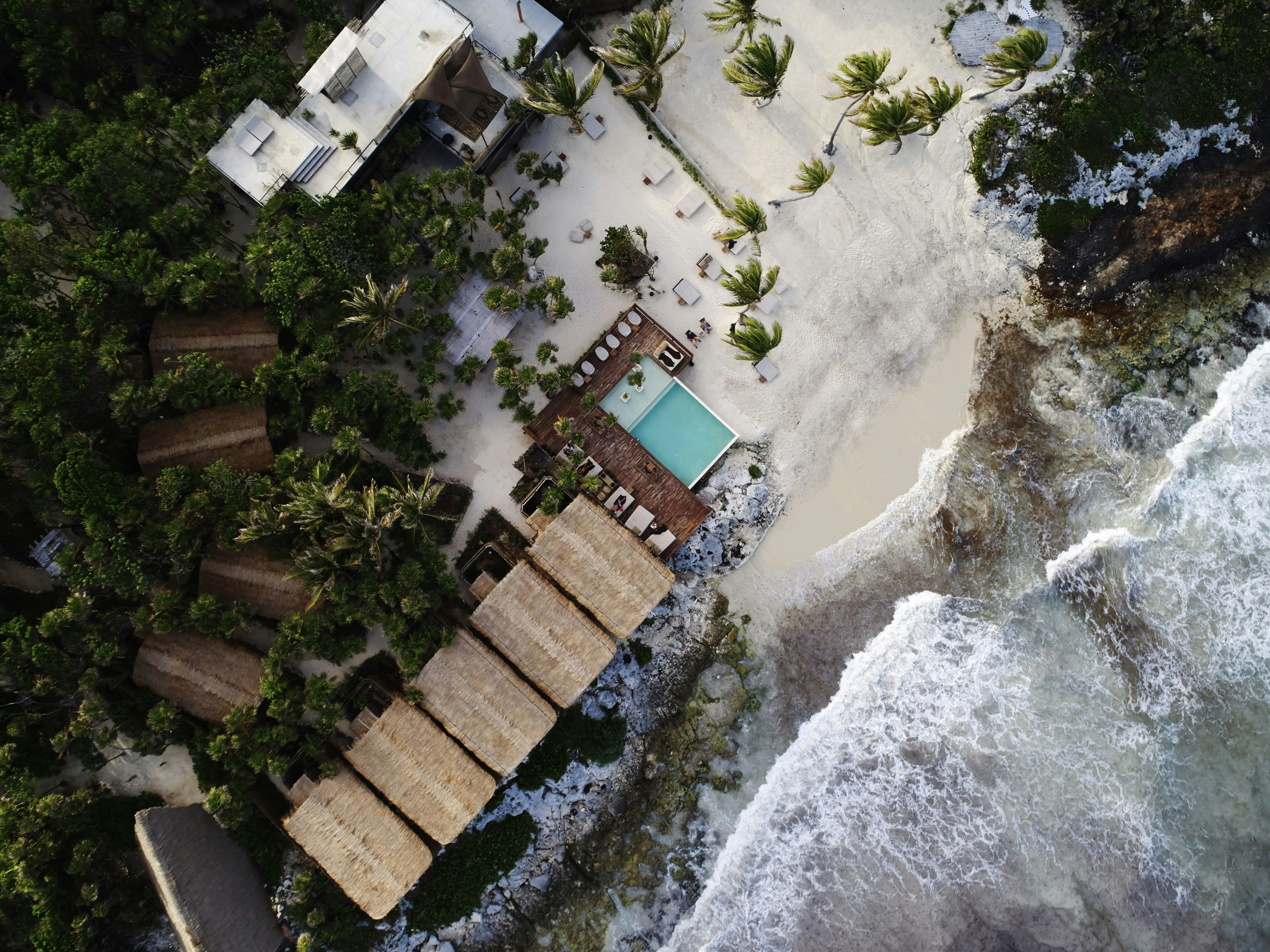 An aerial view of Habitas Tulum's beachside huts.