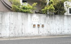 The three shiba inus poking their heads out of the wall in Shimabara, Japan.