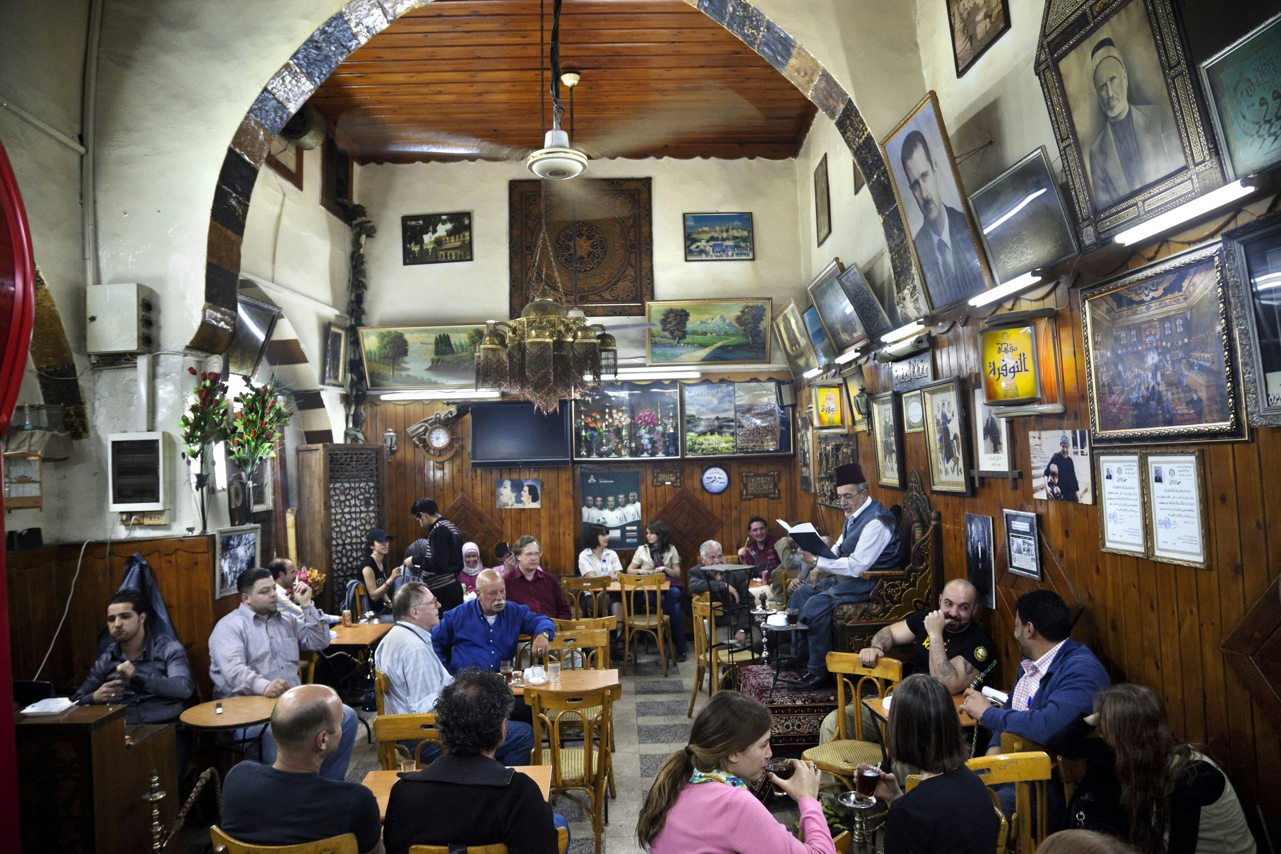A storyteller inside the Nawfara Café in the shadow of the Umayyad Mosque in Damascus.
