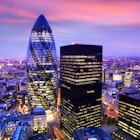 Travel News - UK London Elevated view over financial district and Swiss Reay building at dusk