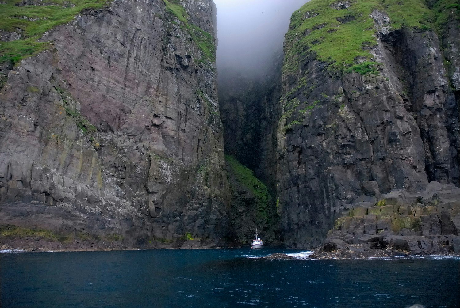 Travel News - Boat sailing into a cave