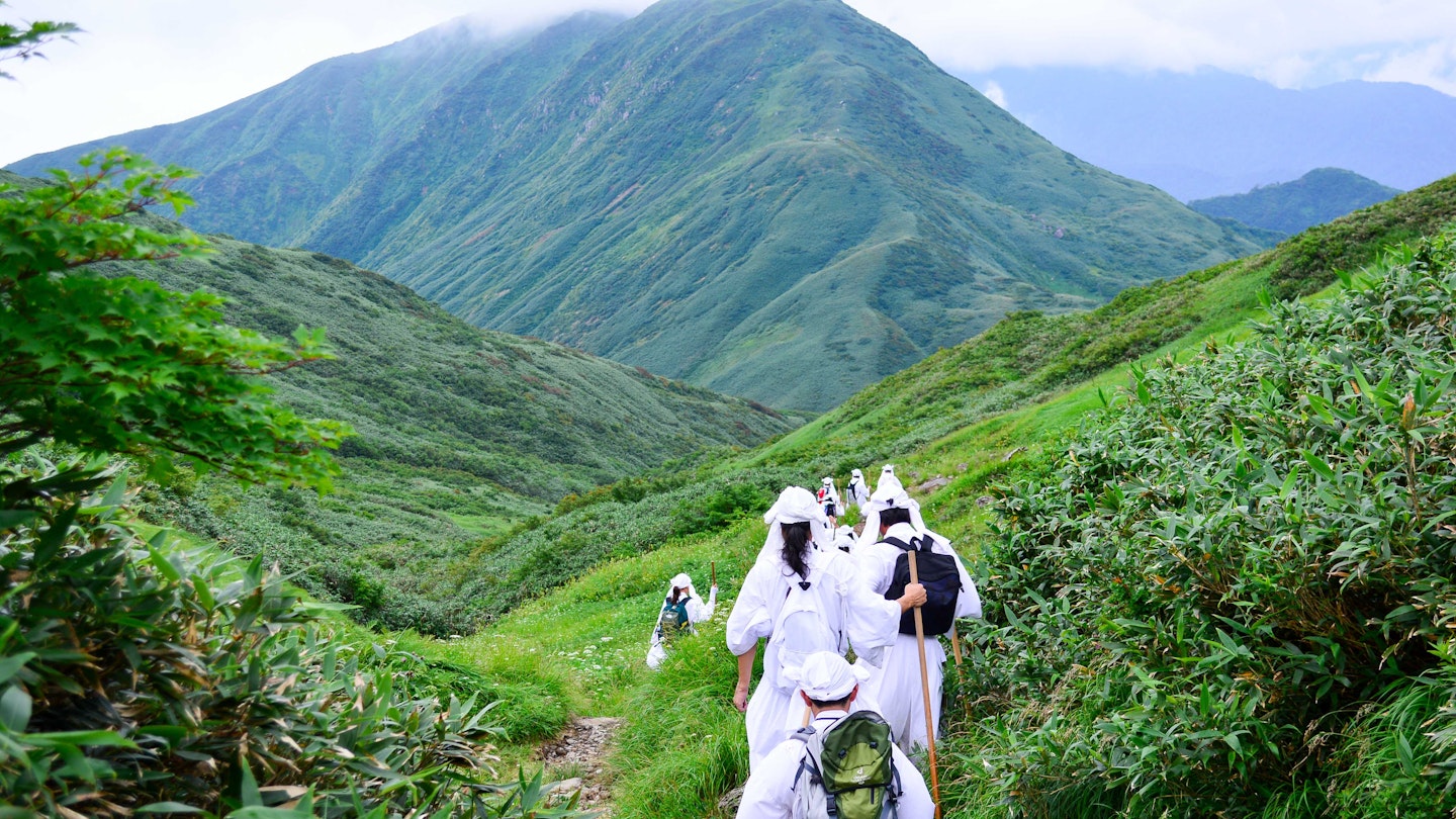 Visitors immerse themselves in nature and take part in hikes across sacred Japanese mountains.