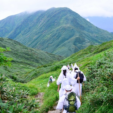 Visitors immerse themselves in nature and take part in hikes across sacred Japanese mountains.