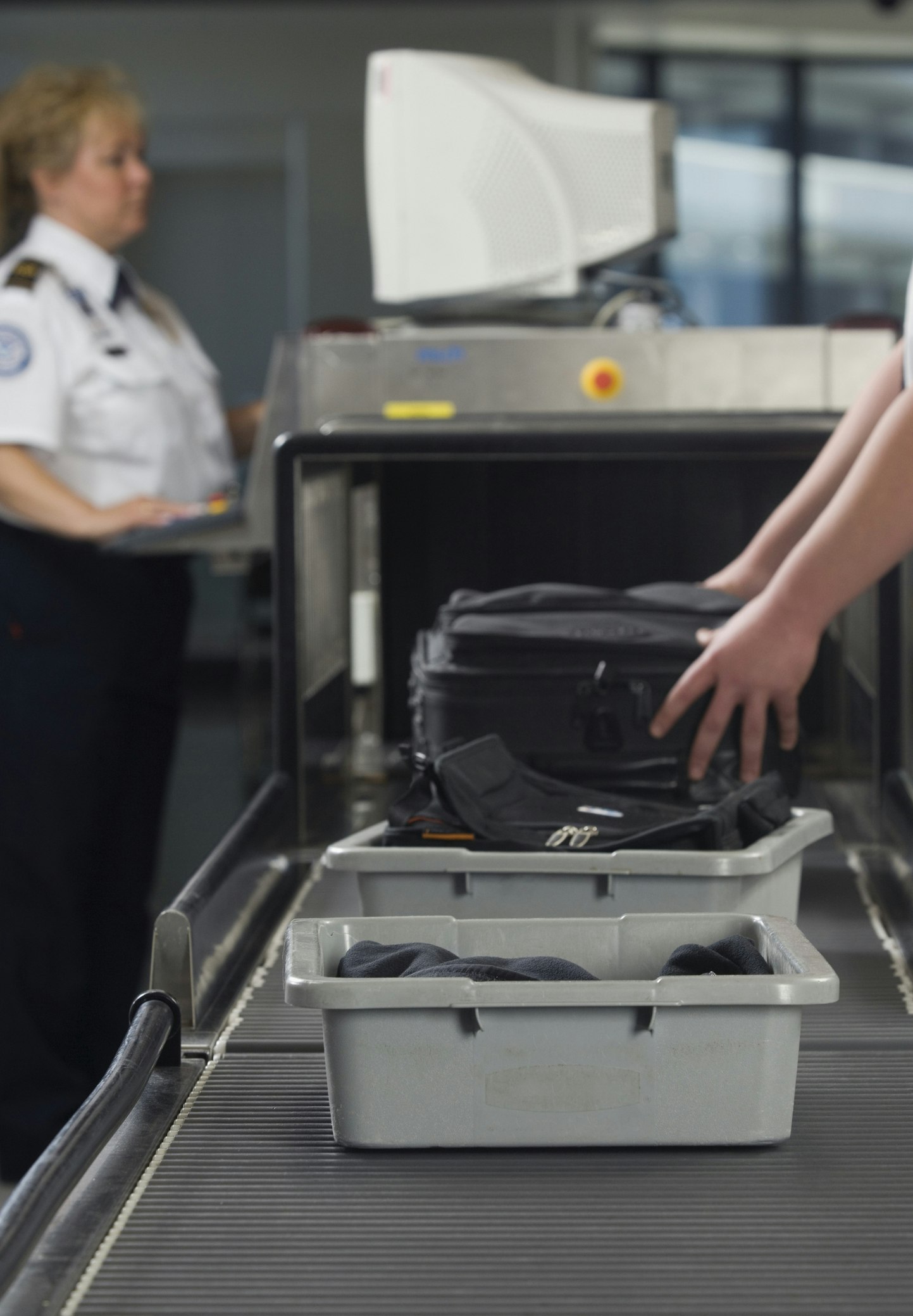 An airport security worker checking baggage