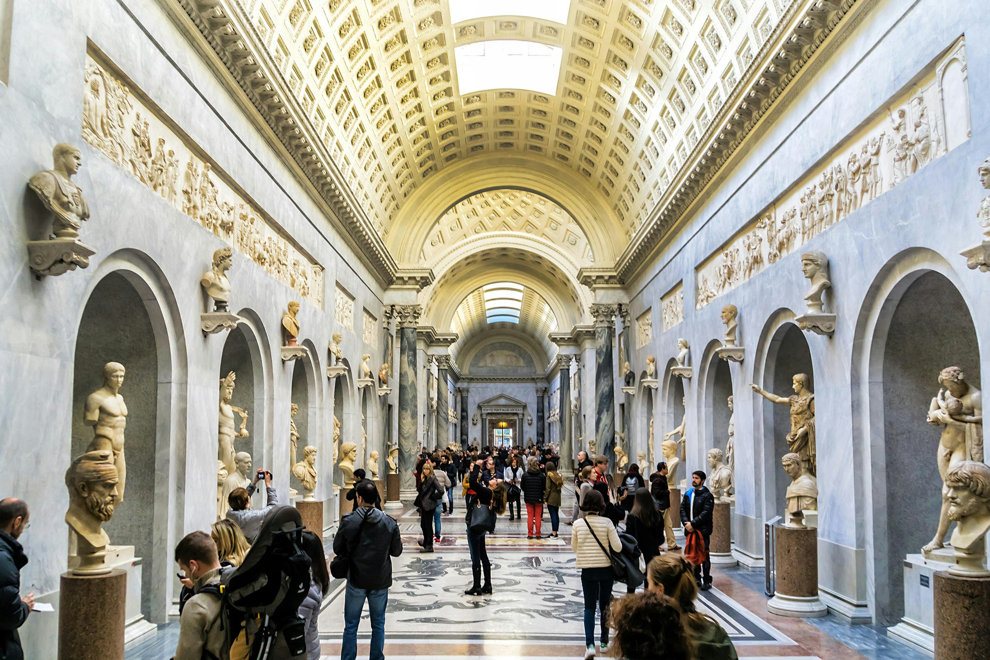 People wandering around the Pio-Clementine Museum in Vatican Museums