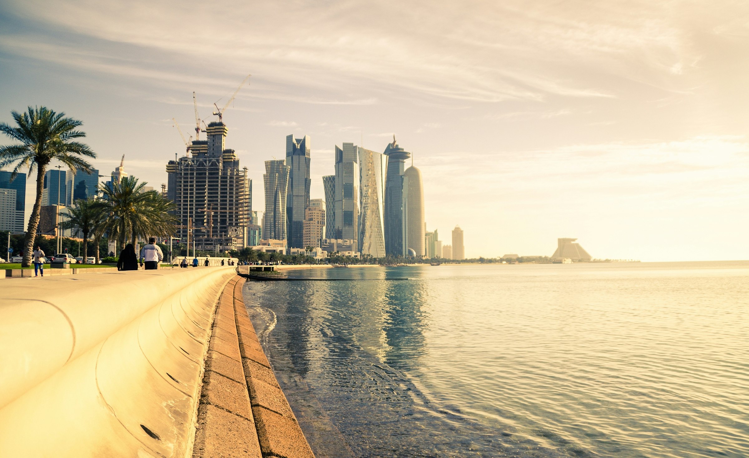 The skyline of Doha in Qatar pictured with a beach