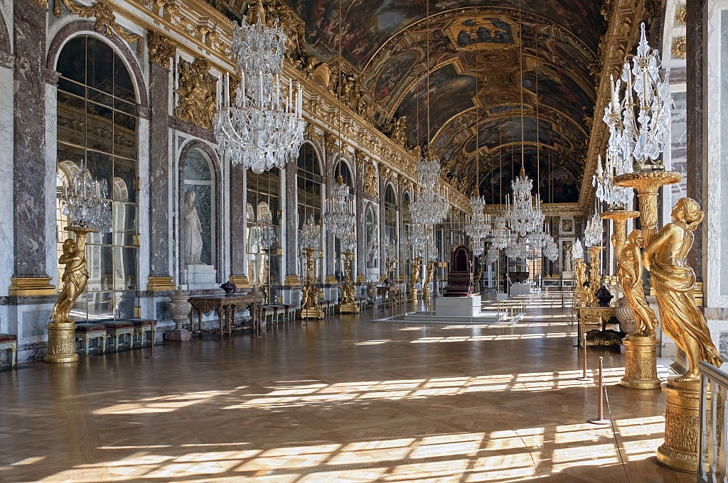 View of the interior of the Palace of Versailles in France, with chandeliers and statues