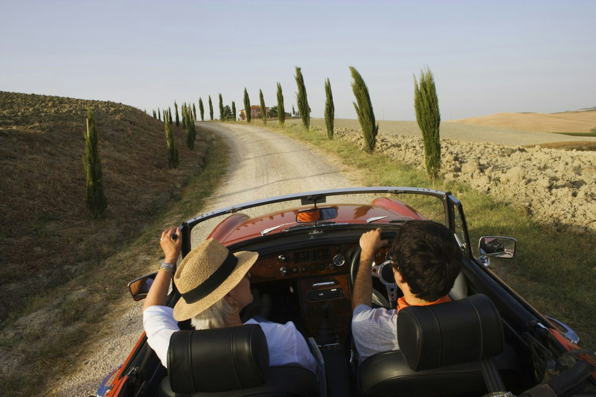 Travel News - Vintage car on a country road at the Montalcino region, Tuscany, Italy, Europe