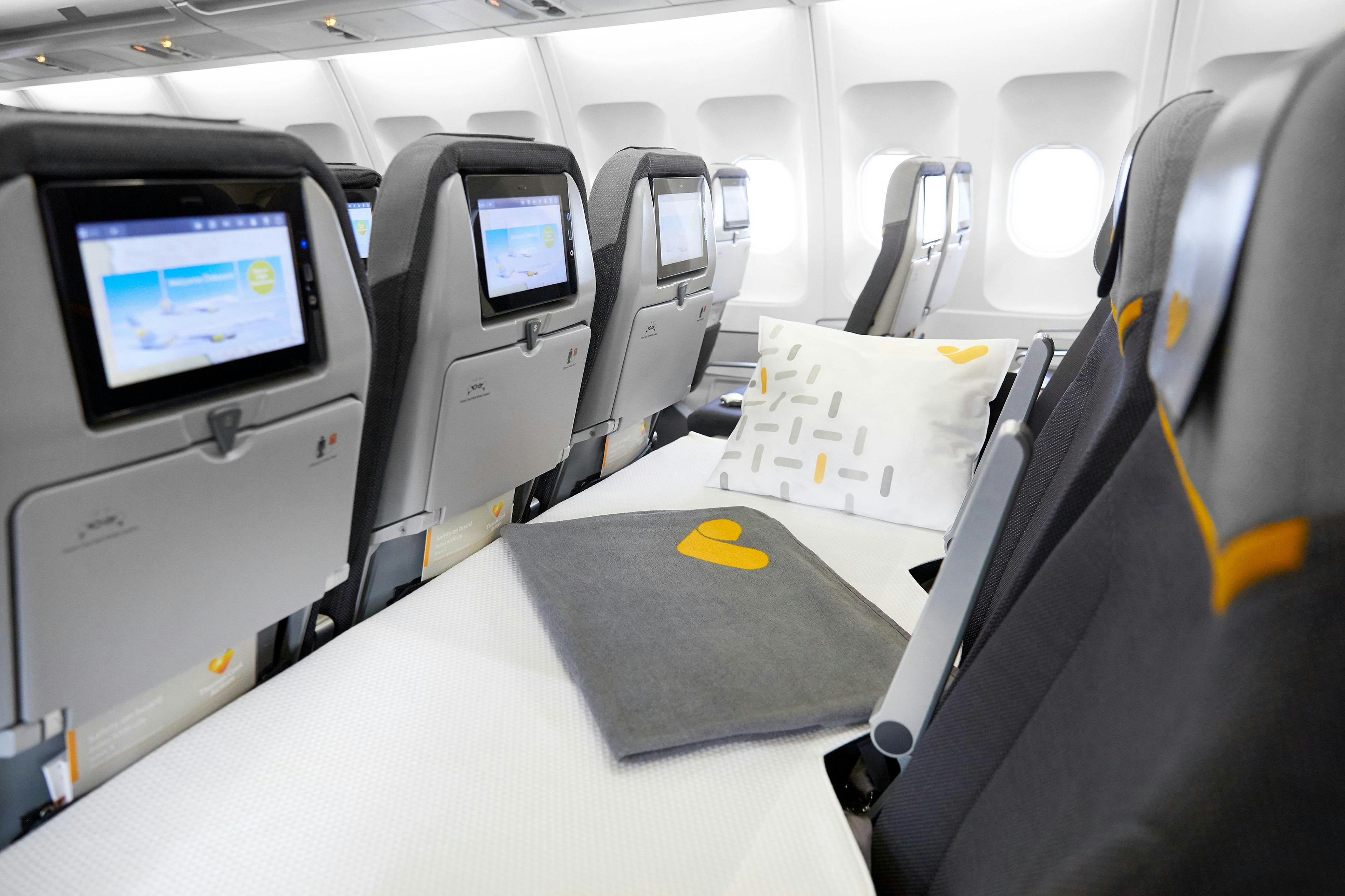 Sleep in a bed in economy class on long-haul flights - Lonely Planet