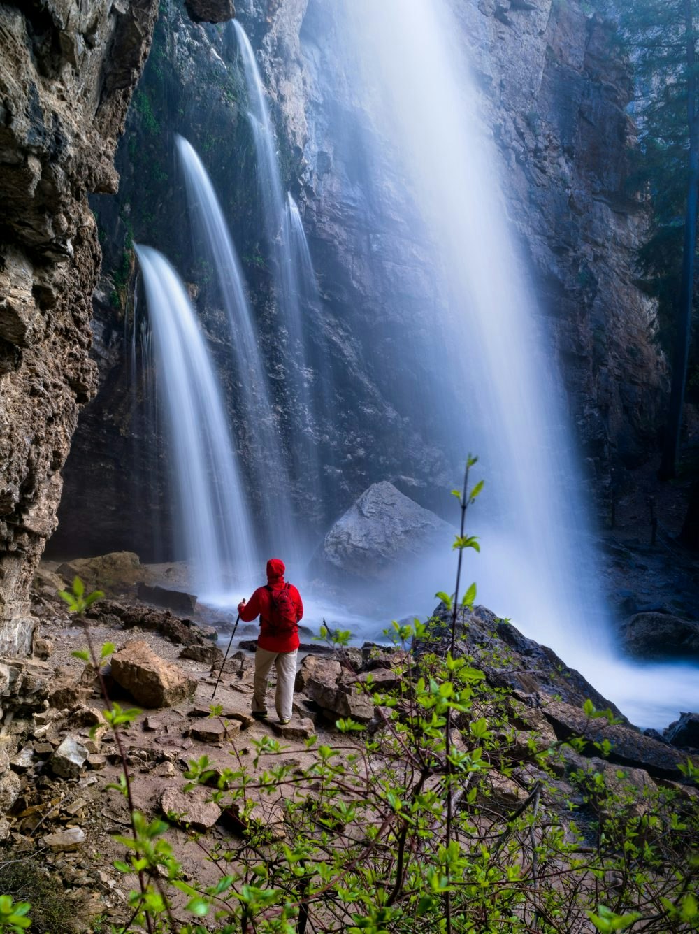 Travel News - Hiking Below Waterfall Hiker in Red