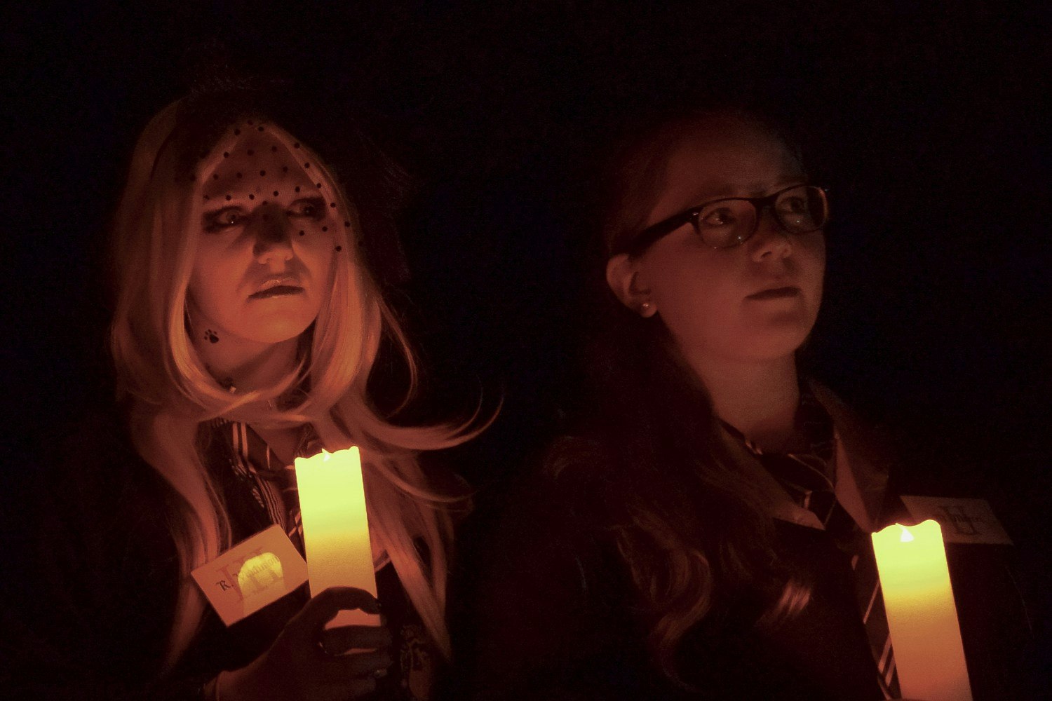 Two students holding candles.