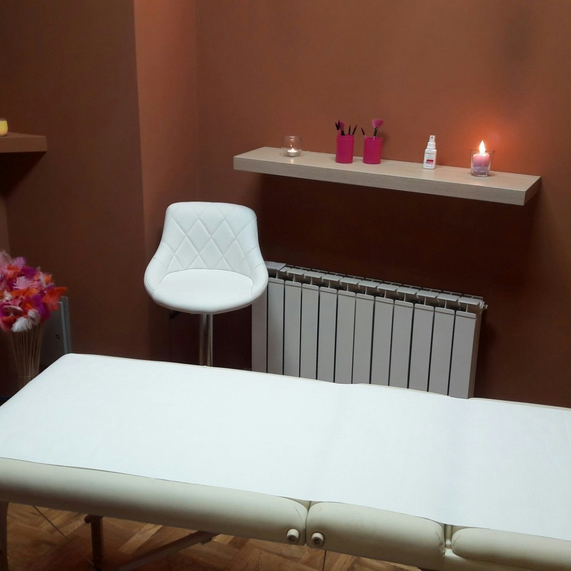 A massage table in a candlelit room.