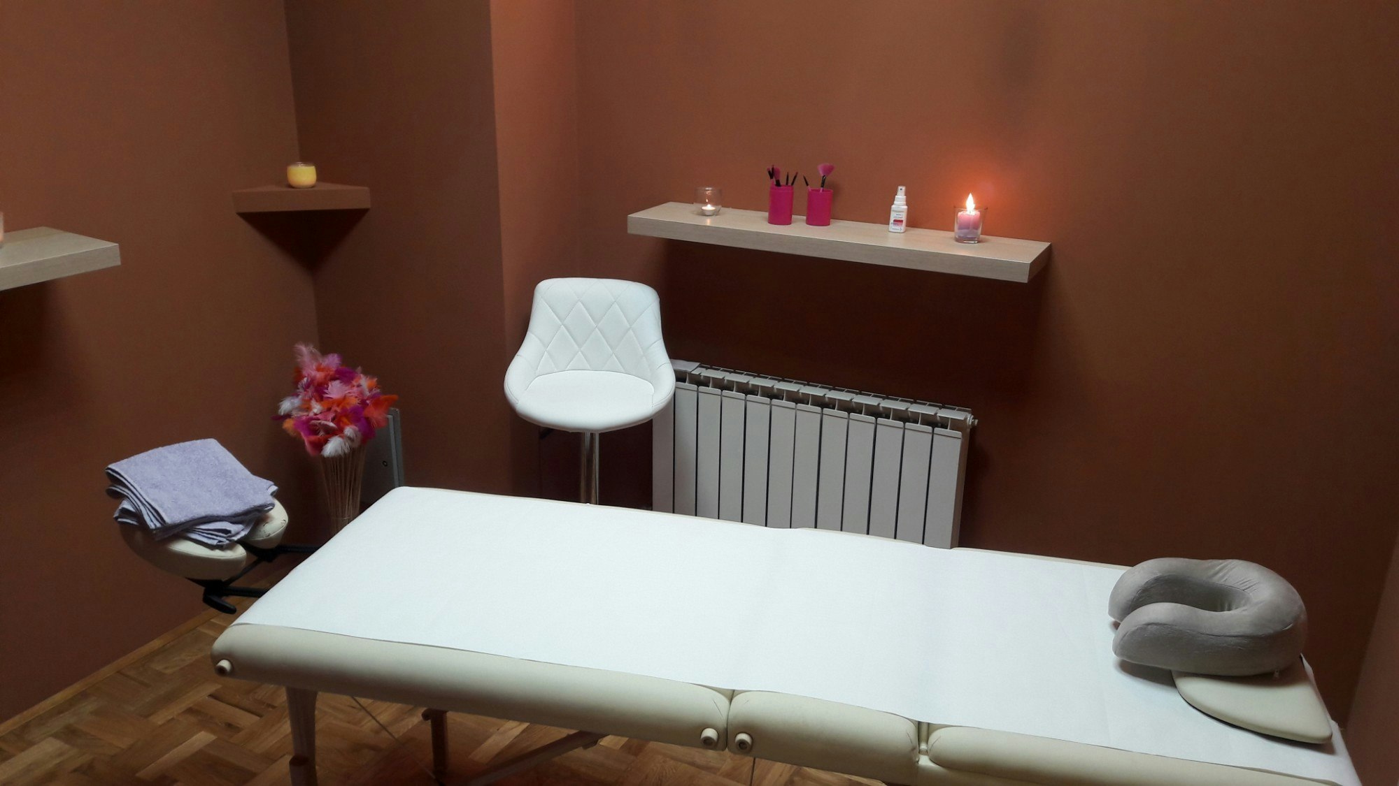 A massage table in a candlelit room.