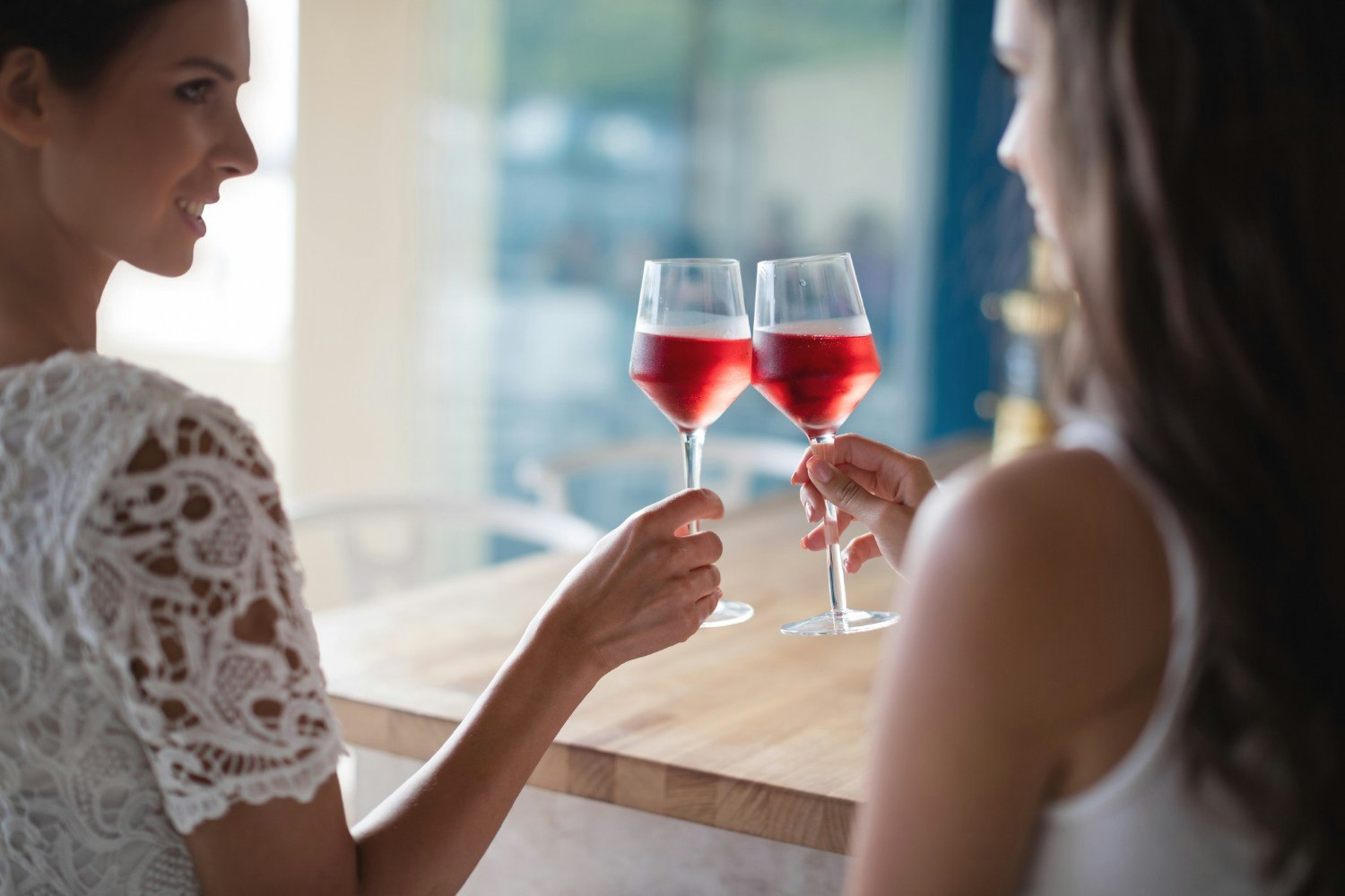 Women toasting with rose wine in restaurant
