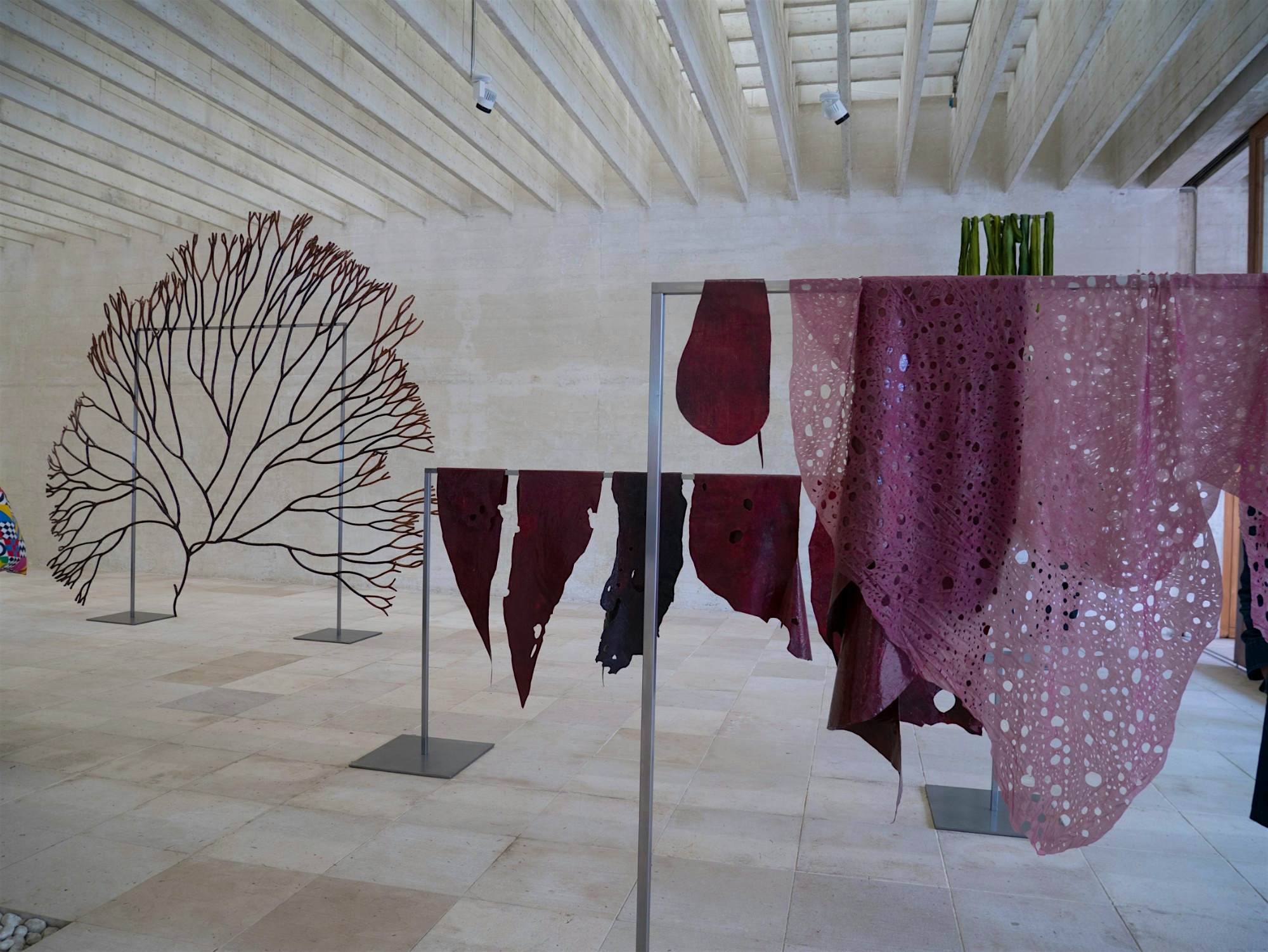 Travel News - biennaleart Purple-coloured fabrics draped over bars.