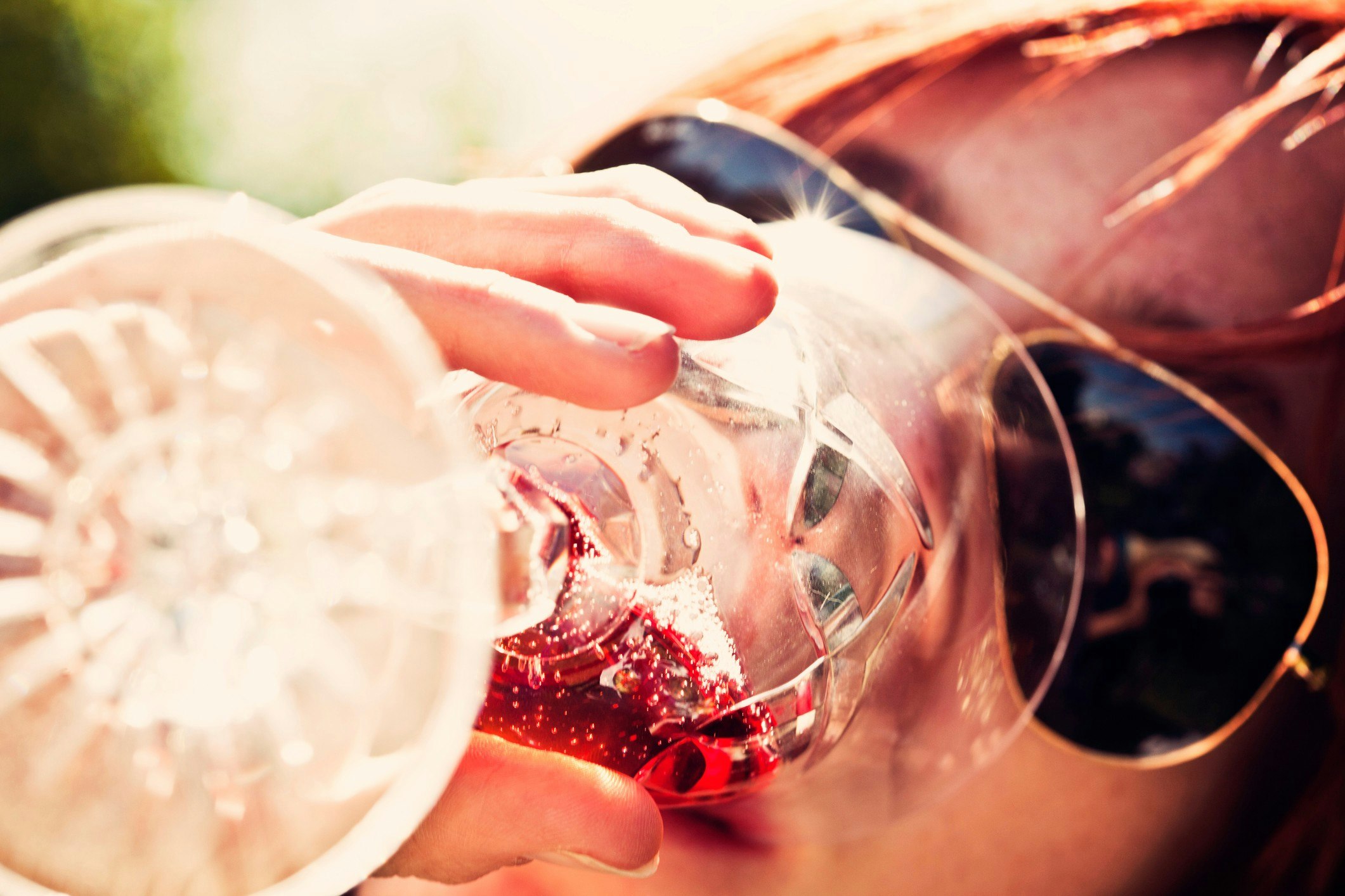 Woman in sunglasses drinking wine