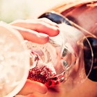 Woman in sunglasses drinking wine