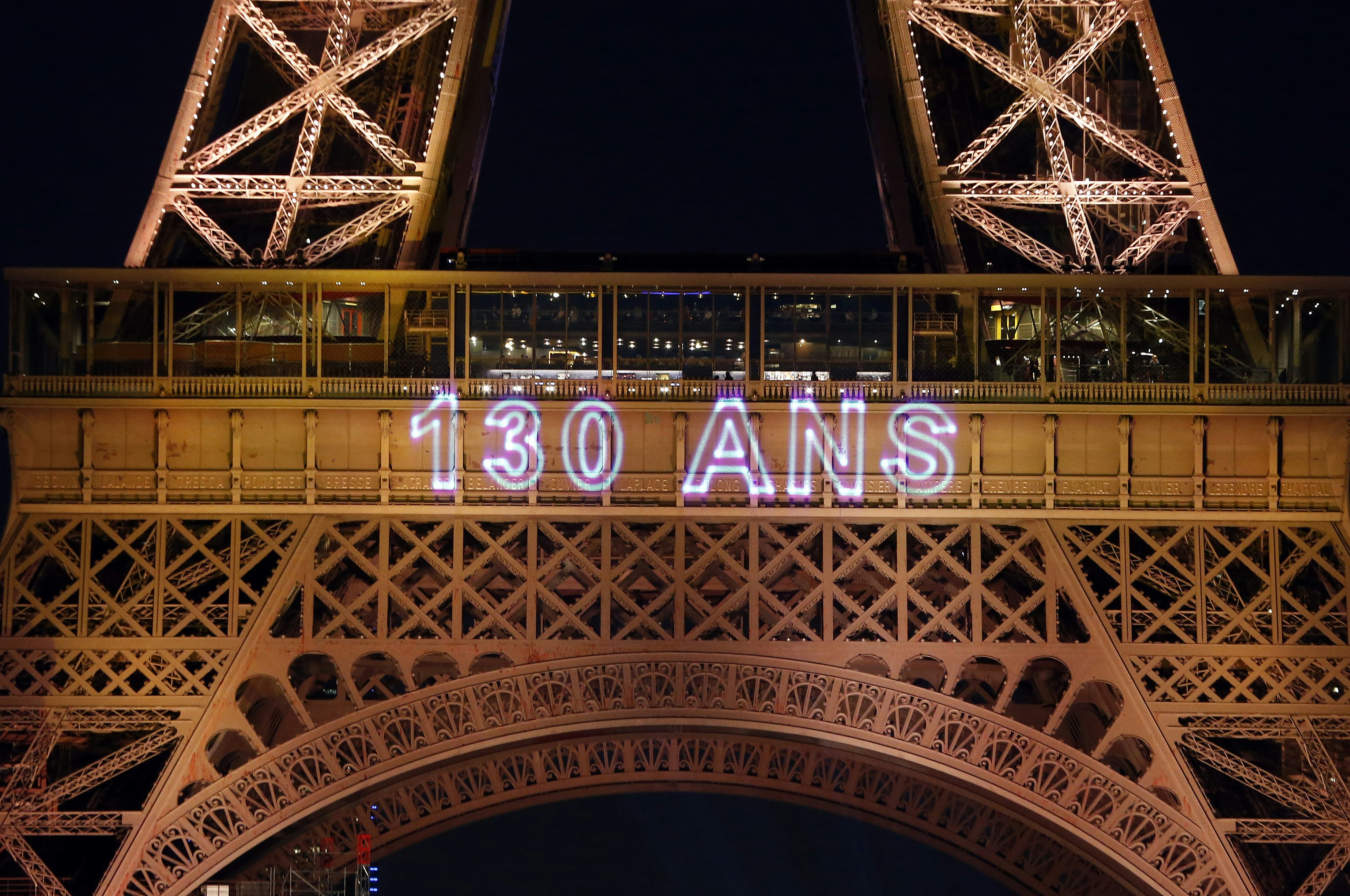 The Eiffel Tower is lit up to mark 130 years since it was built. 