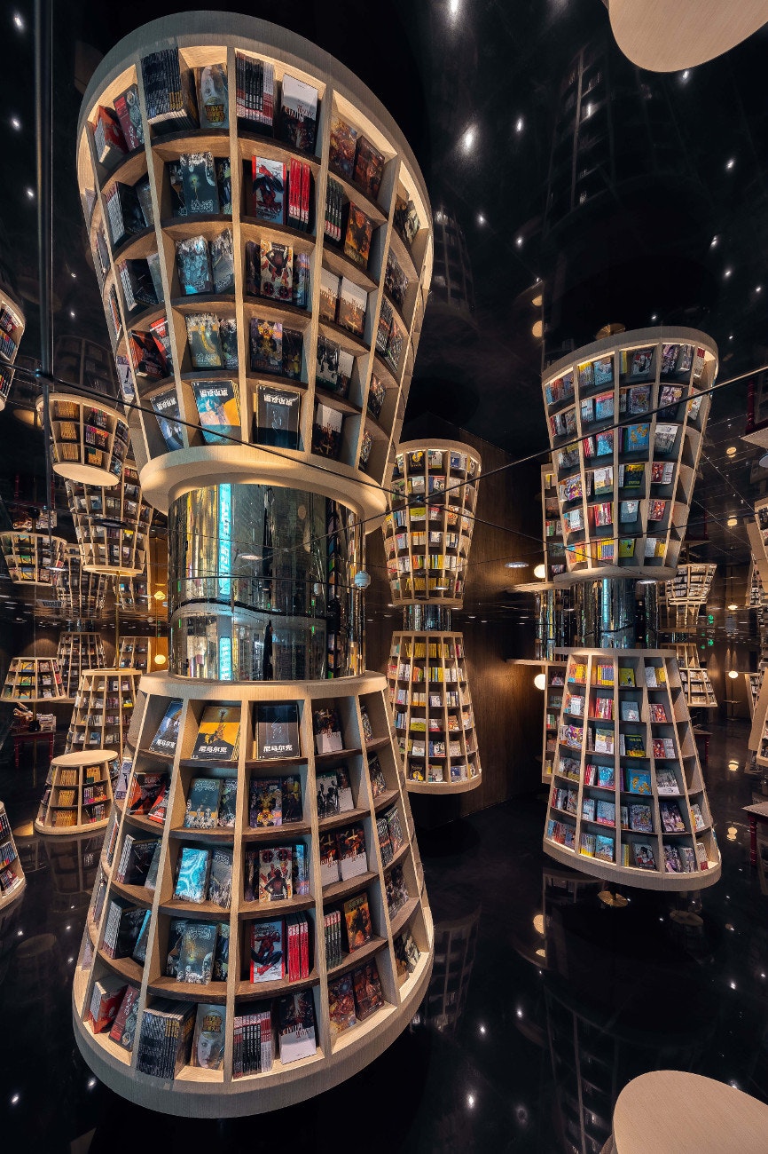 Lampshade-shaped bookshelves greet visitors inside the store.