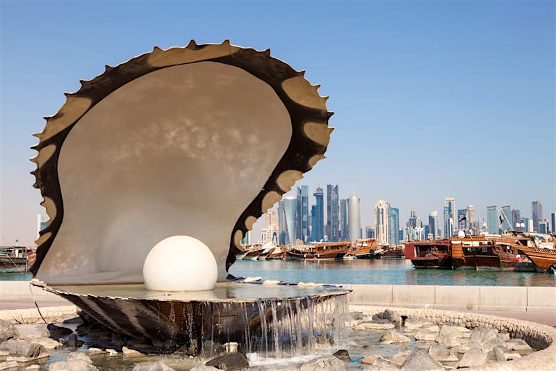 Travel News - Doha1 Fountain with cityscape of Doha in the background.