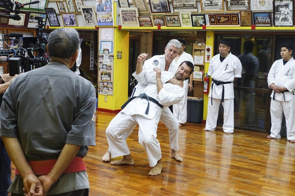 Anthony Bourdain attempting tegumi wrestling in Okinawa, Japan.